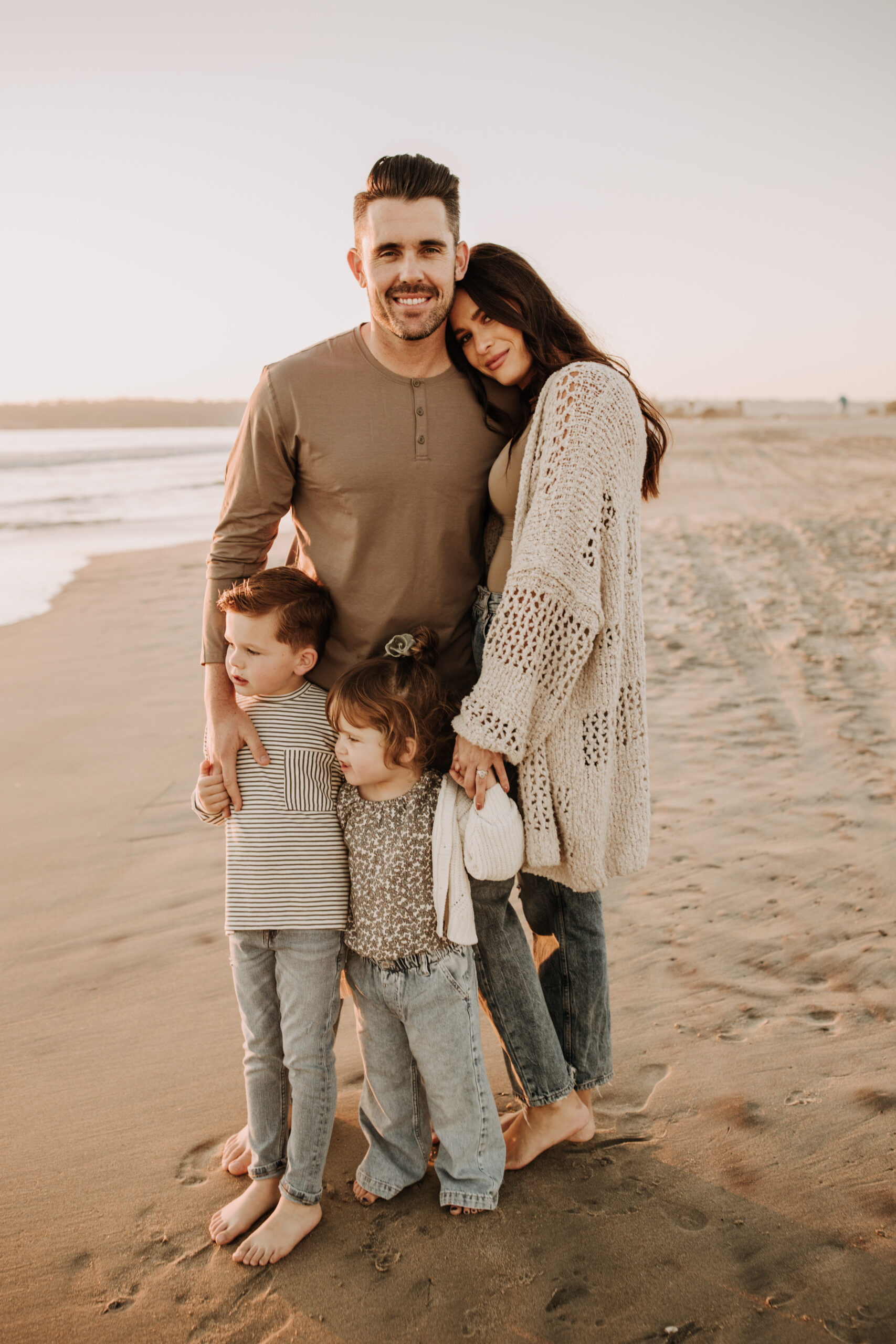 warm neutral sunset beach photos family photos on the beach golden hour family of four candid family photos love San Diego family photographer Sabrina kinsella