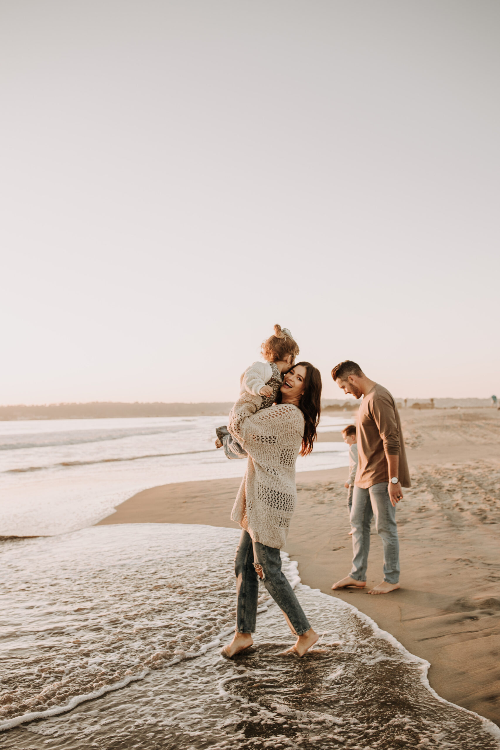 warm neutral sunset beach photos family photos on the beach golden hour family of four candid family photos love San Diego family photographer Sabrina kinsella