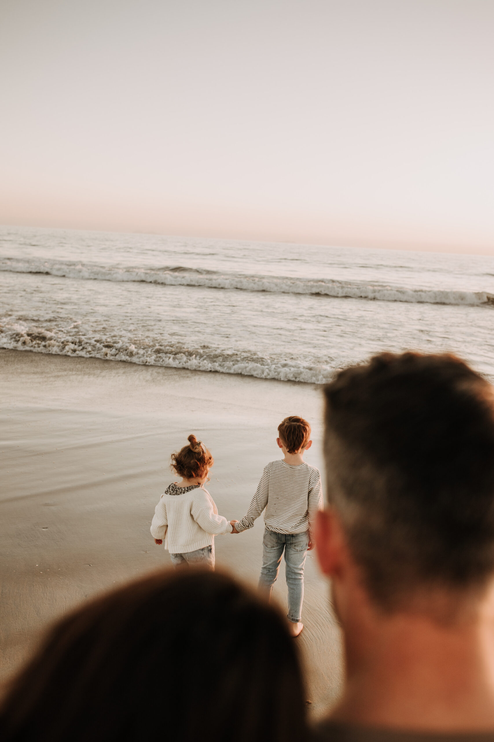 warm neutral sunset beach photos family photos on the beach golden hour family of four candid family photos love San Diego family photographer Sabrina kinsella