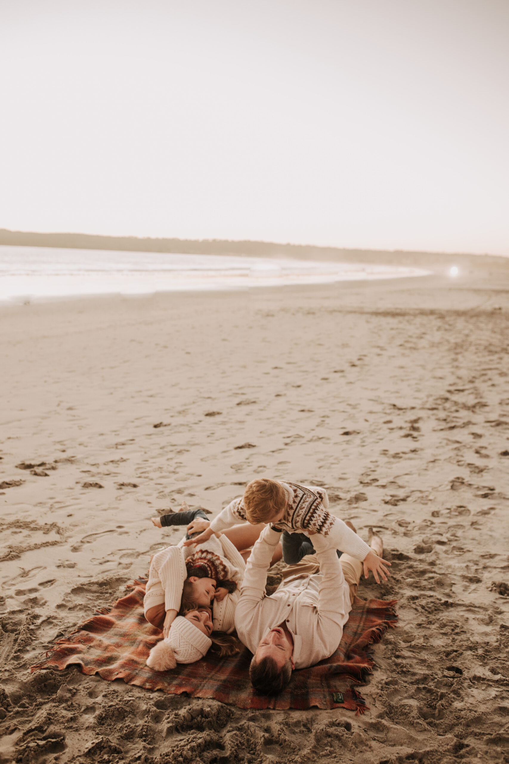 San Diego family photos warm sunset beach photos family of four candid family moments golden hour light beach San Diego family photographer Sabrina Kinsella