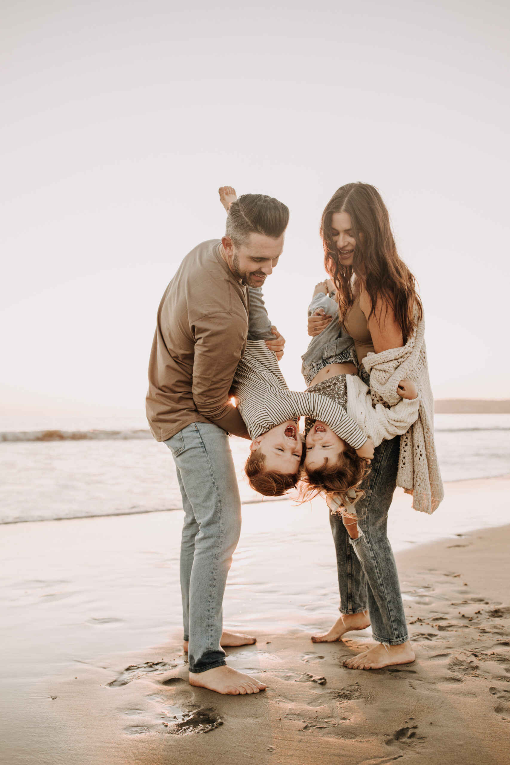 warm neutral sunset beach photos family photos on the beach golden hour family of four candid family photos love San Diego family photographer Sabrina kinsella