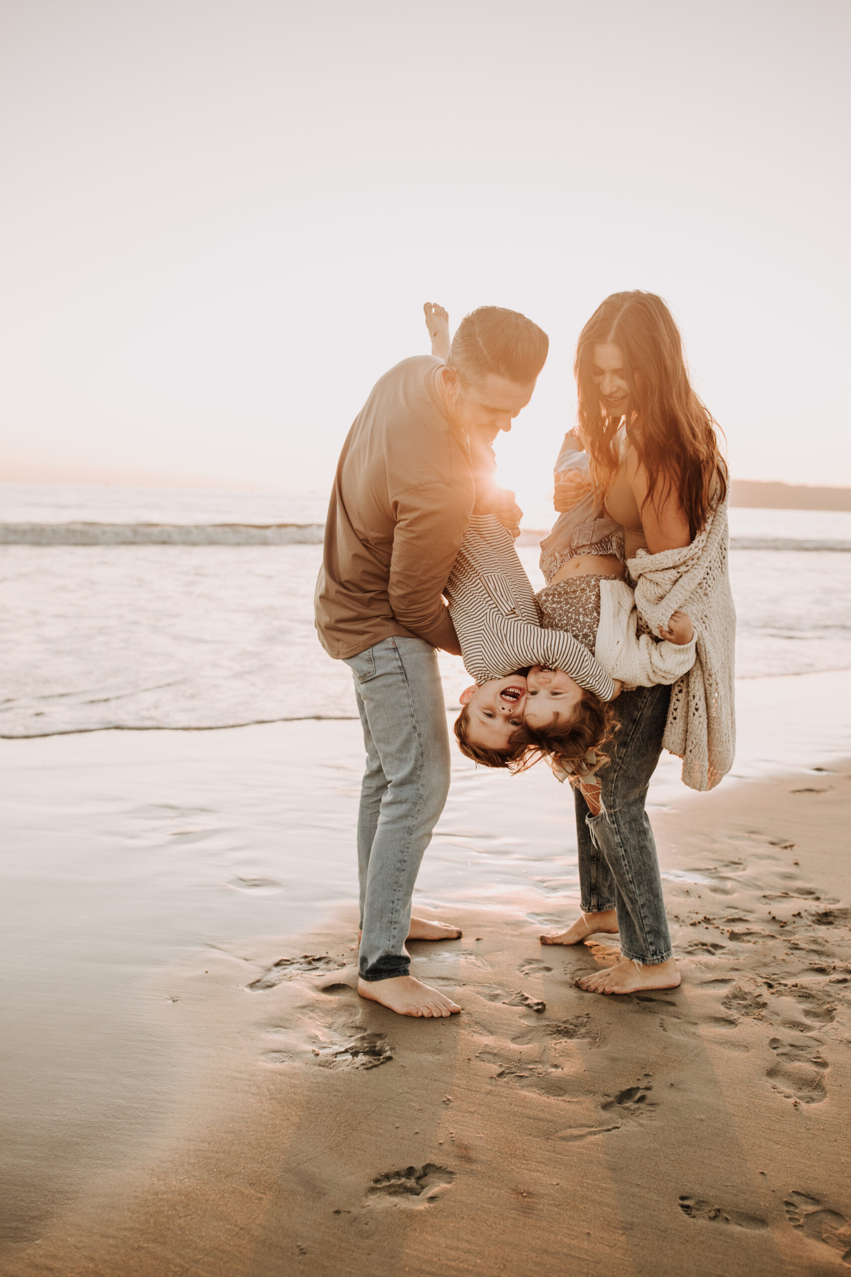 warm neutral sunset beach photos family photos on the beach golden hour family of four candid family photos love San Diego family photographer Sabrina kinsella