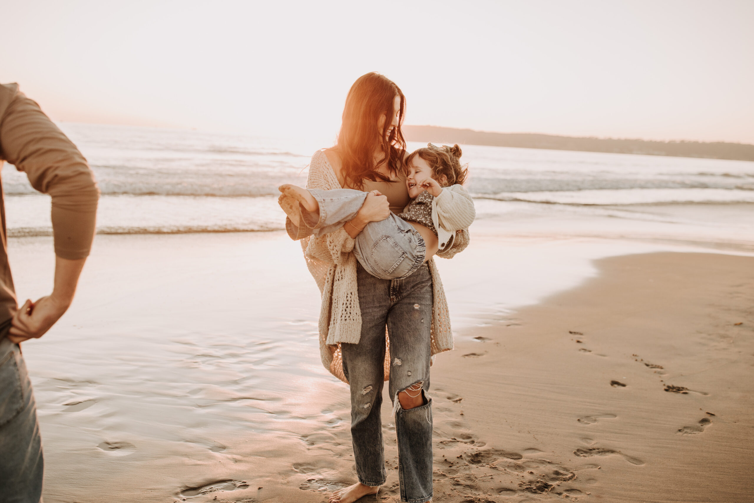 warm neutral sunset beach photos family photos on the beach golden hour family of four candid family photos love San Diego family photographer Sabrina kinsella