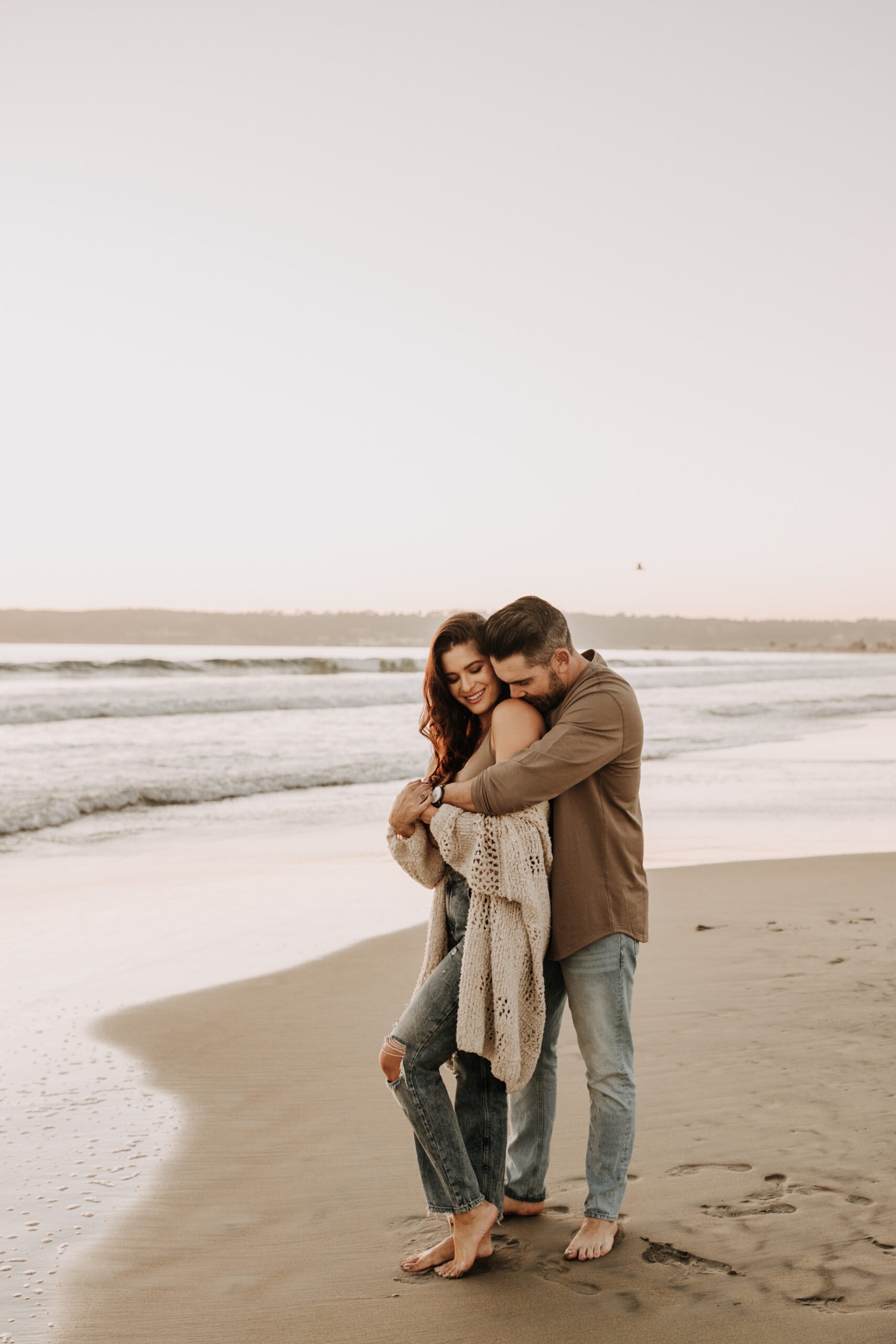 warm neutral sunset beach photos family photos on the beach golden hour family of four candid family photos love San Diego family photographer Sabrina kinsella