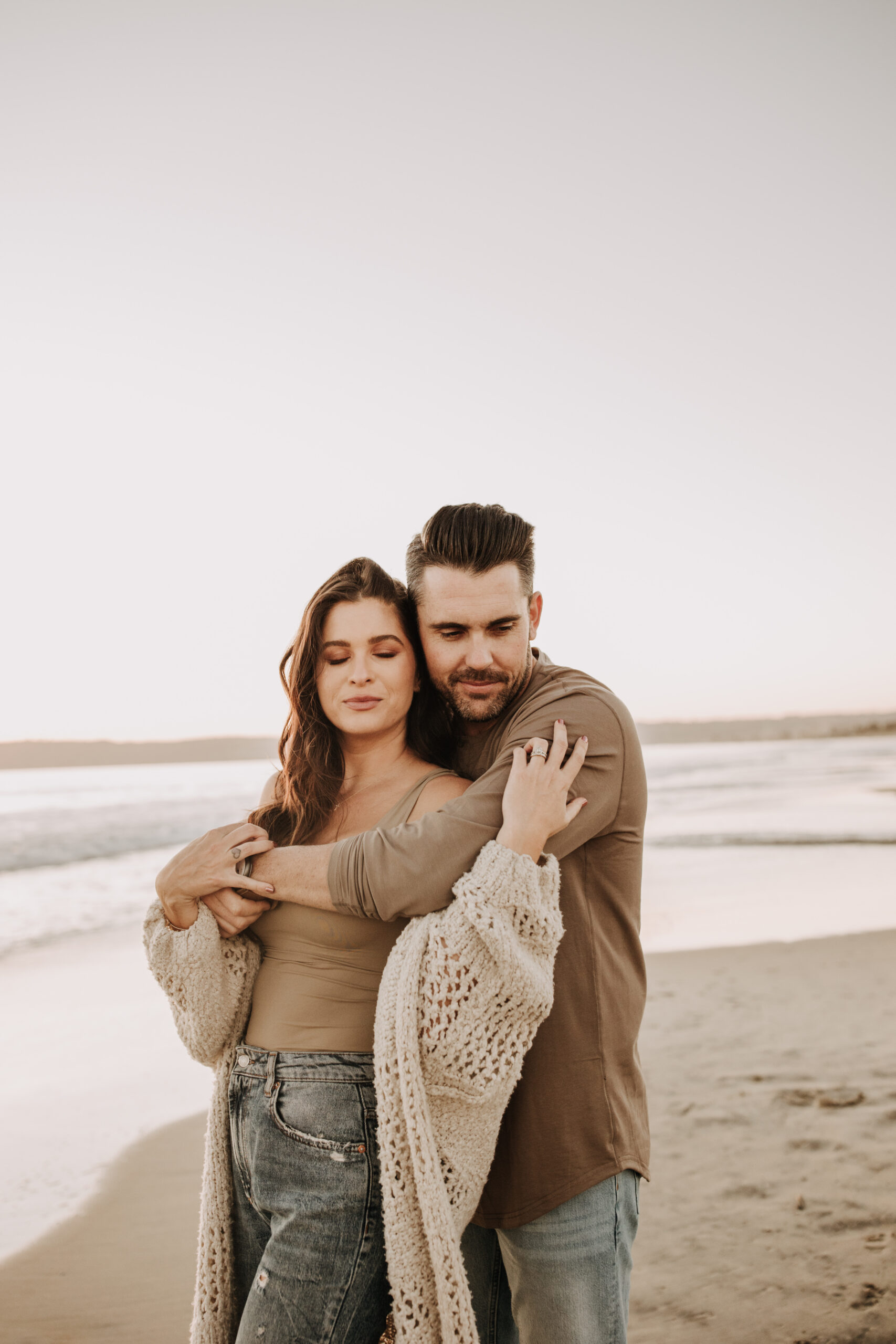 warm neutral sunset beach photos family photos on the beach golden hour family of four candid family photos love San Diego family photographer Sabrina kinsella