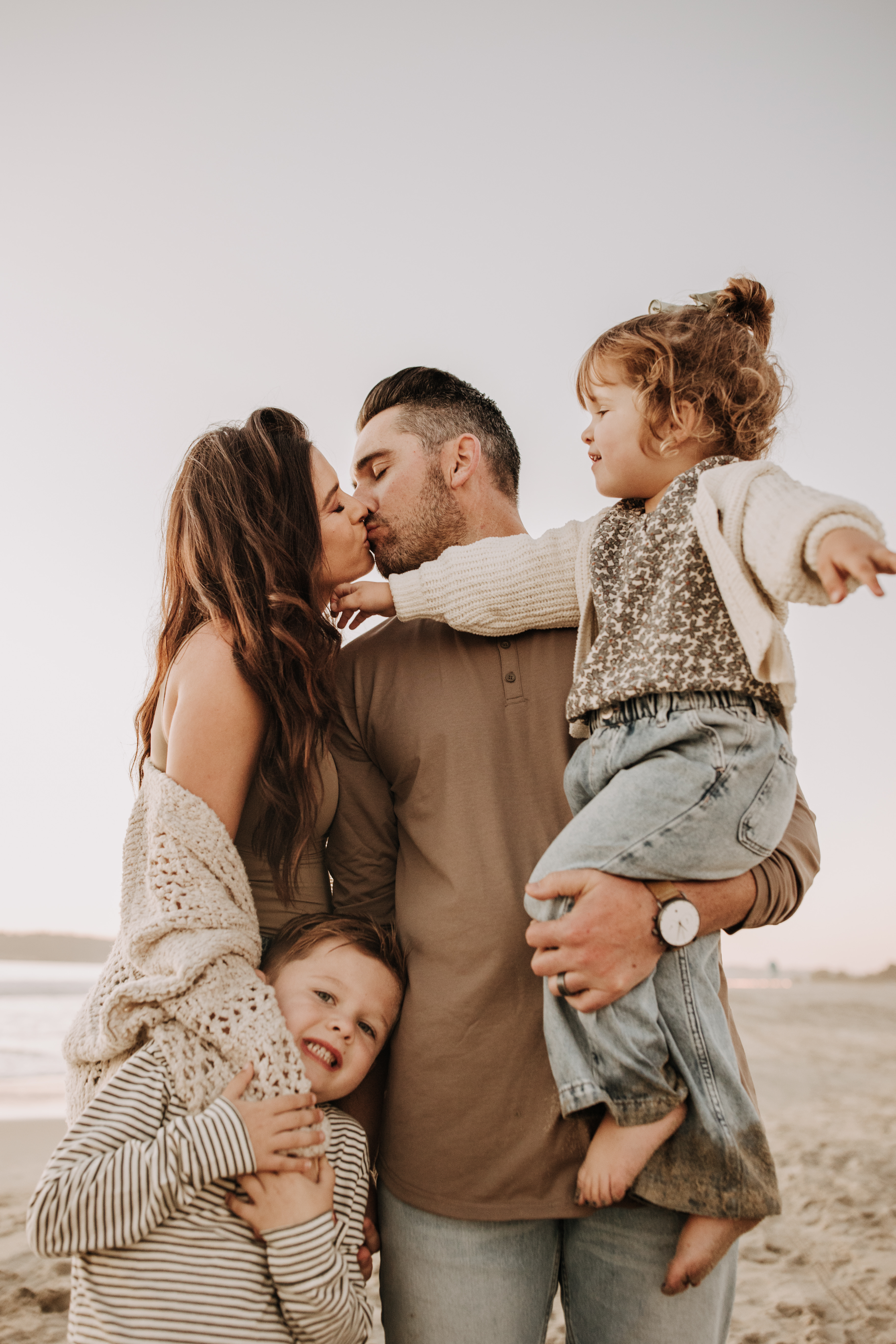 warm neutral sunset beach photos family photos on the beach golden hour family of four candid family photos love San Diego family photographer Sabrina kinsella 