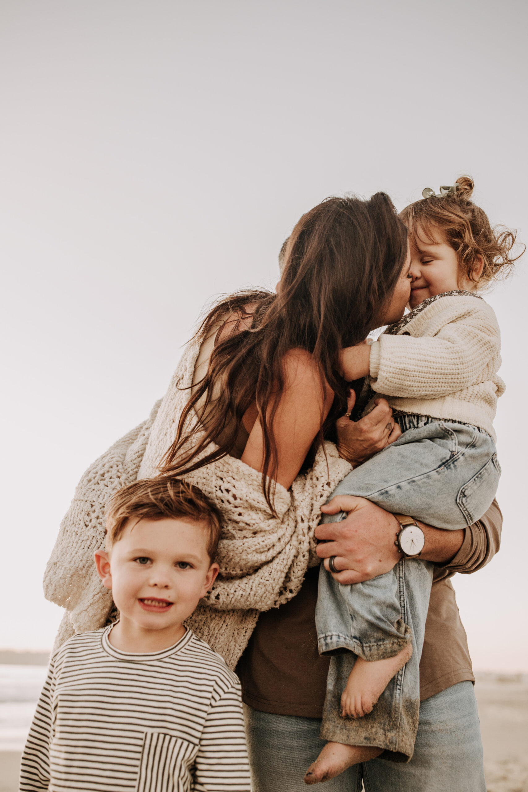 warm neutral sunset beach photos family photos on the beach golden hour family of four candid family photos love San Diego family photographer Sabrina kinsella