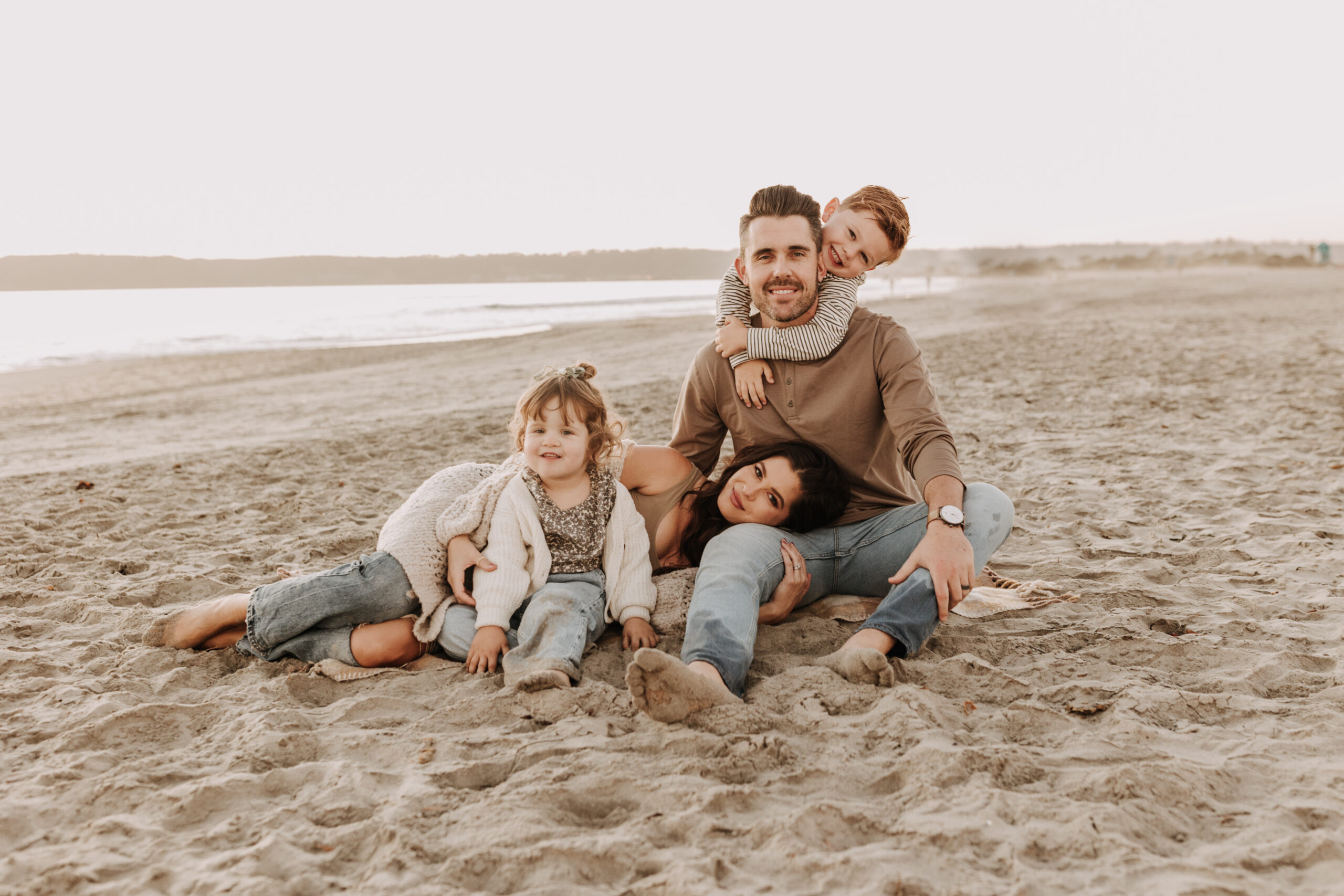 warm neutral sunset beach photos family photos on the beach golden hour family of four candid family photos love San Diego family photographer Sabrina kinsella