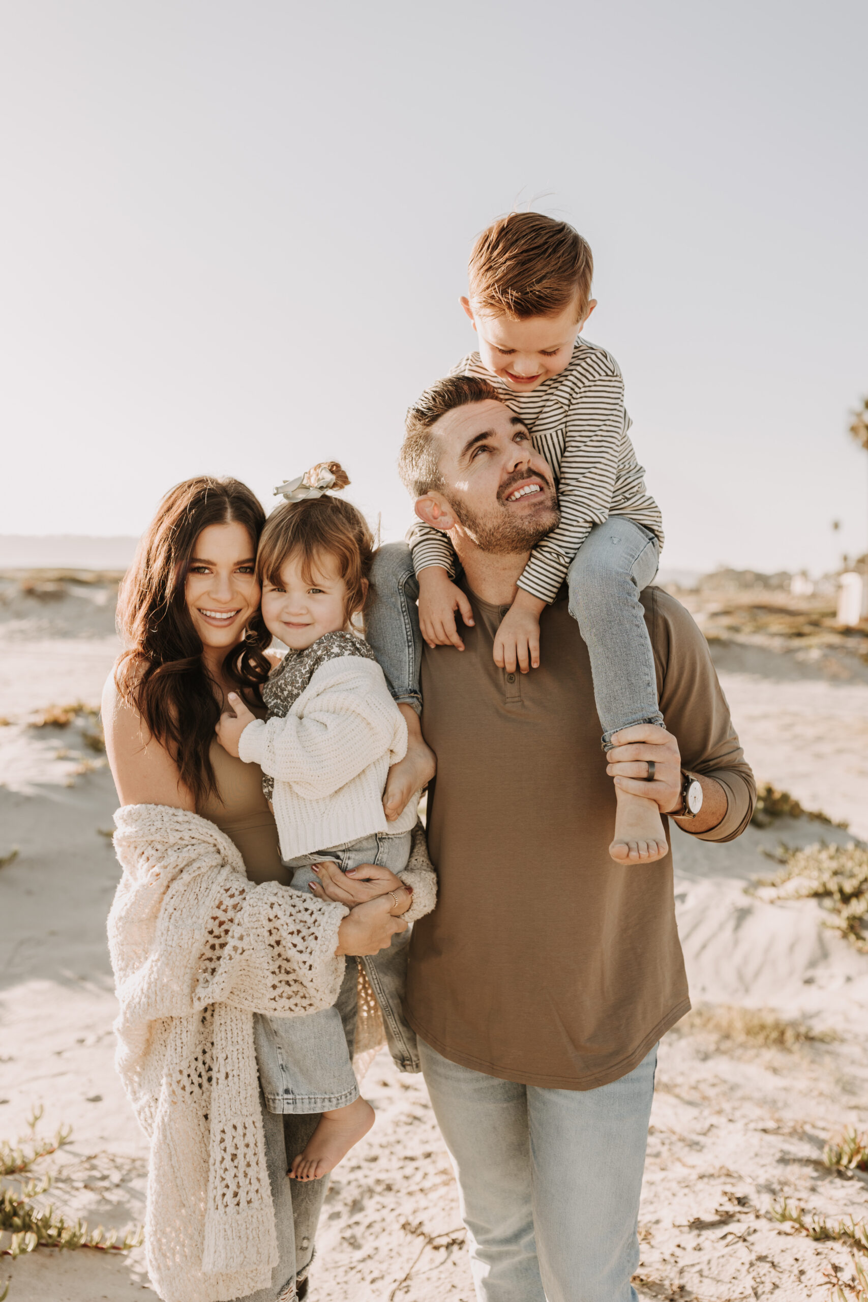 warm neutral sunset beach photos family photos on the beach golden hour family of four candid family photos love San Diego family photographer Sabrina kinsella