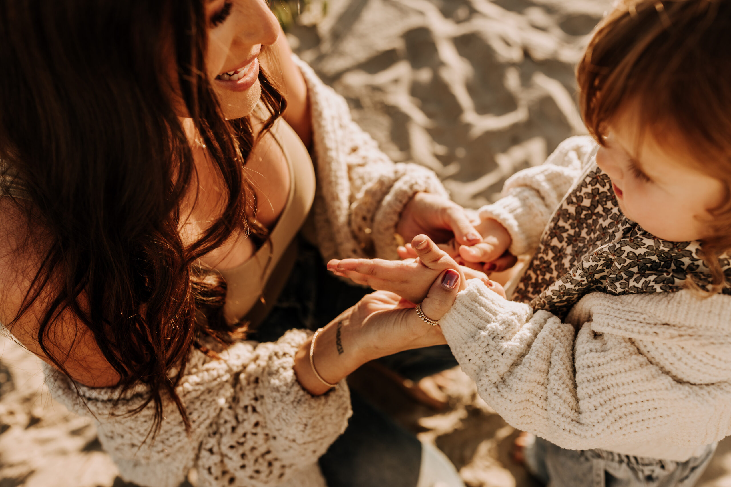 warm neutral sunset beach photos family photos on the beach golden hour family of four candid family photos love San Diego family photographer Sabrina kinsella