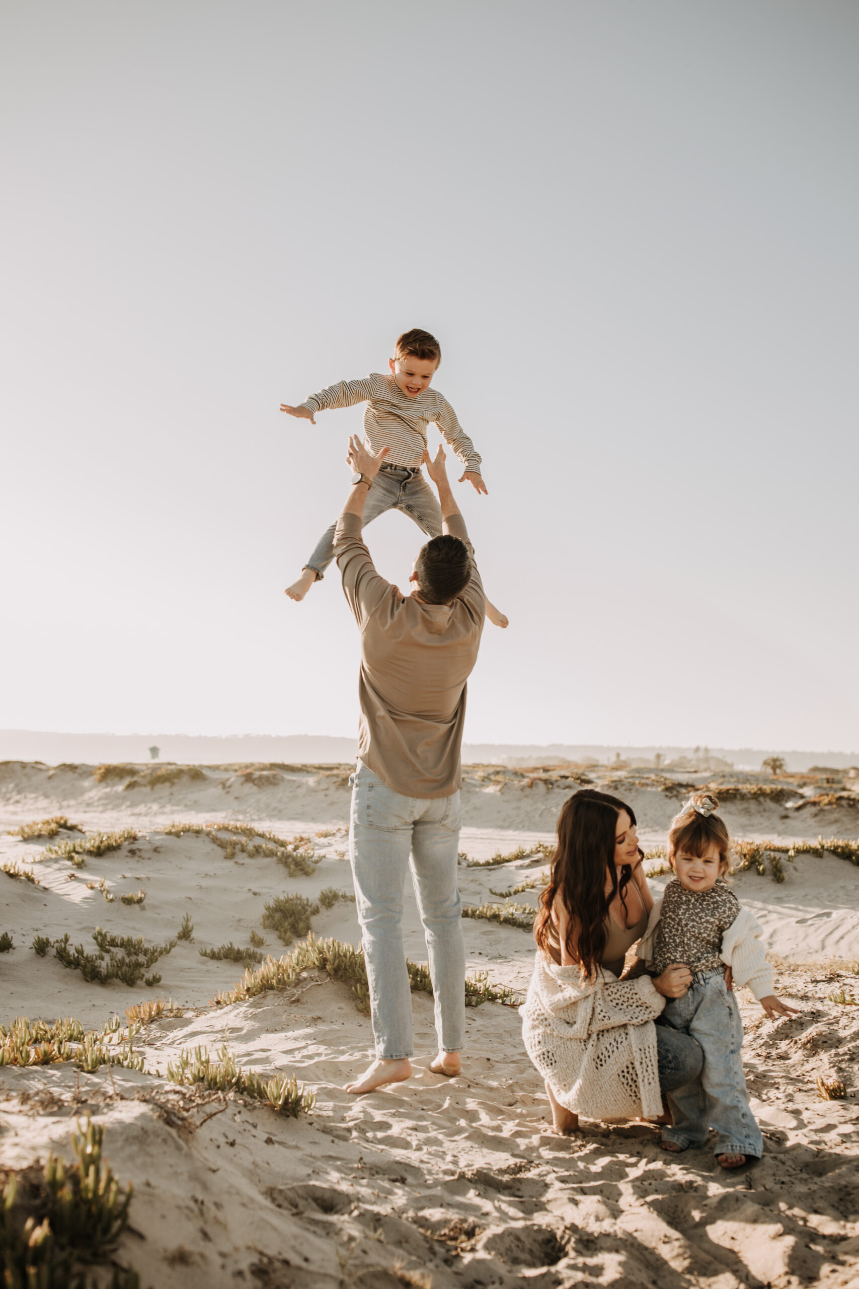 warm neutral sunset beach photos family photos on the beach golden hour family of four candid family photos love San Diego family photographer Sabrina kinsella