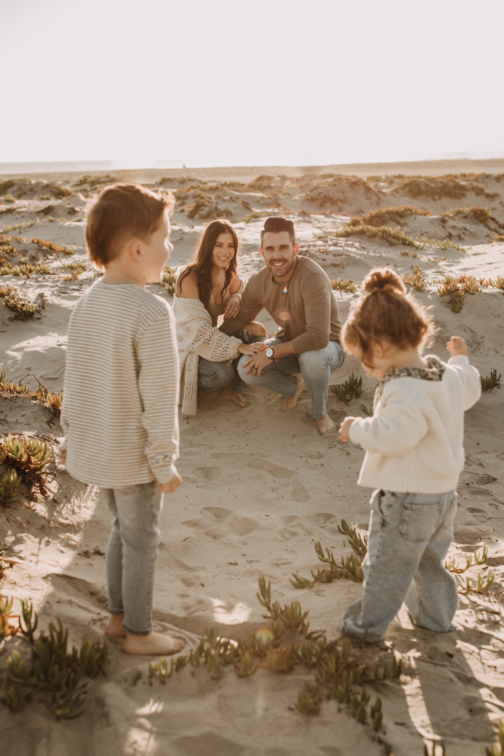 warm neutral sunset beach photos family photos on the beach golden hour family of four candid family photos love San Diego family photographer Sabrina kinsella