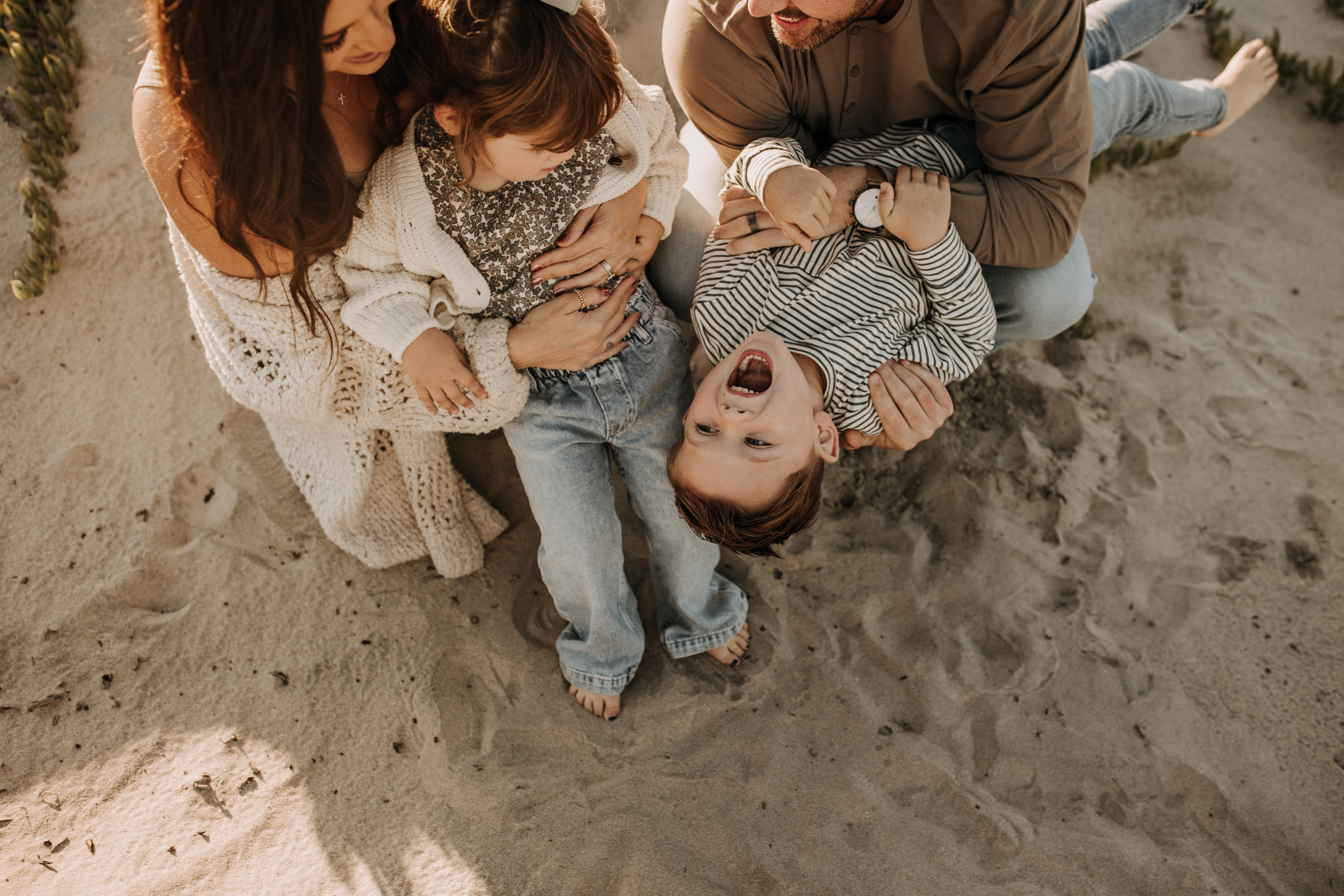 warm neutral sunset beach photos family photos on the beach golden hour family of four candid family photos love San Diego family photographer Sabrina kinsella 