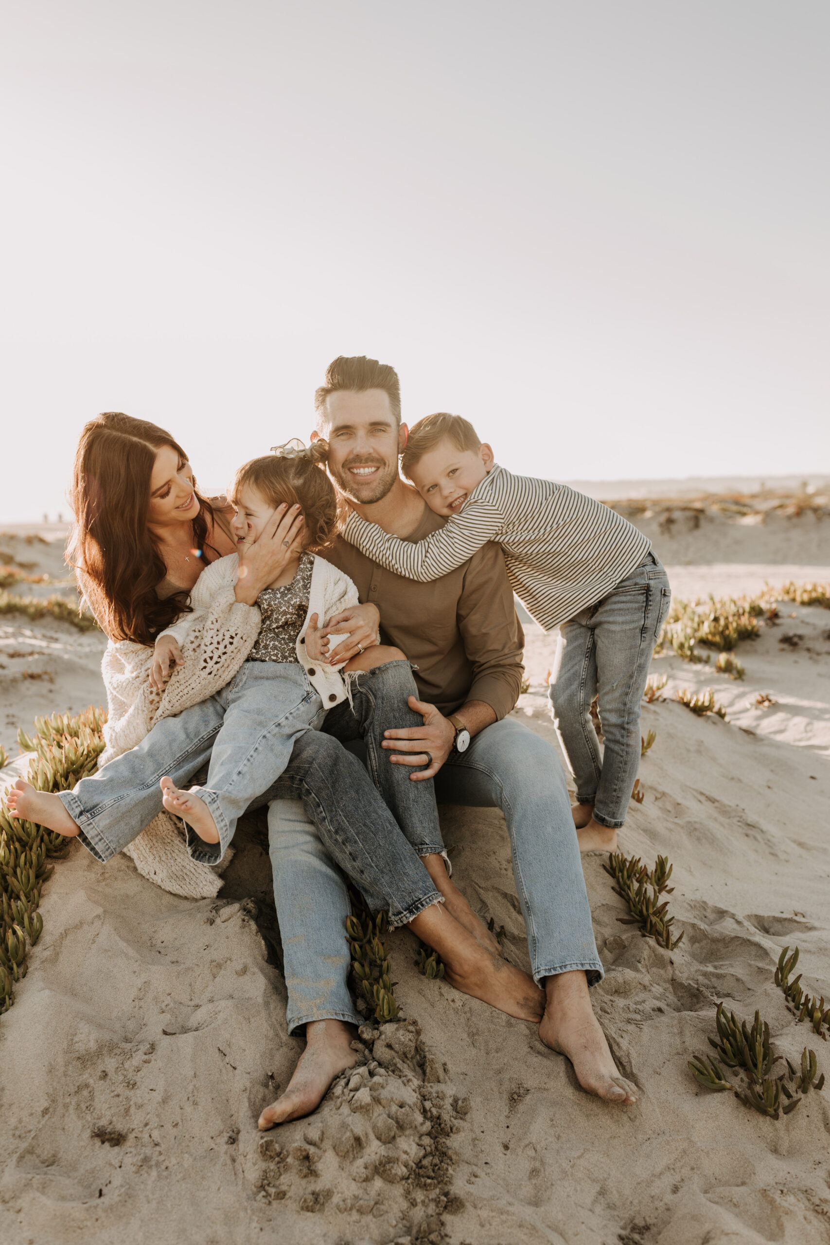 warm neutral sunset beach photos family photos on the beach golden hour family of four candid family photos love San Diego family photographer Sabrina kinsella