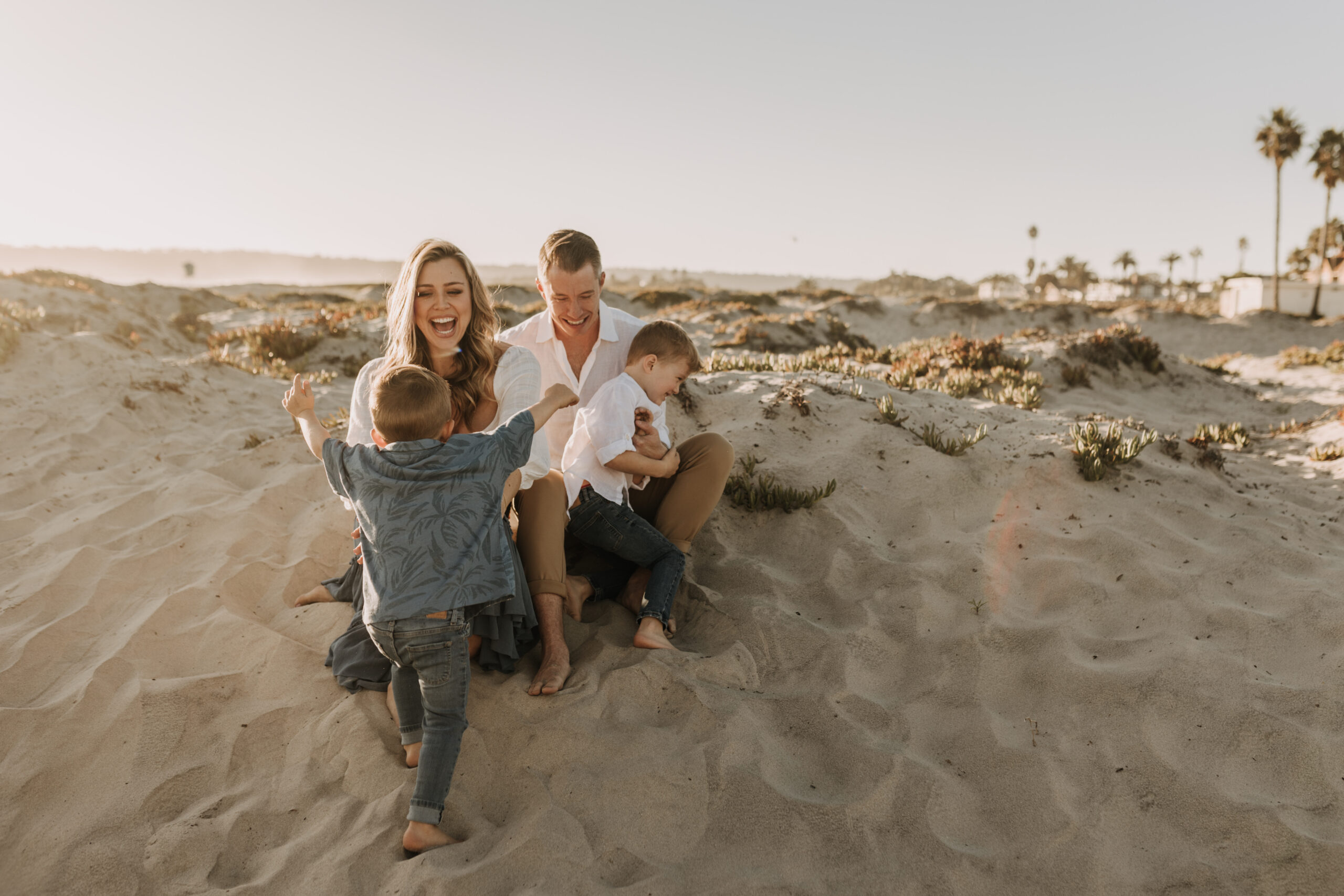 San Diego family photos warm sunset beach photos family of four candid family moments golden hour light beach San Diego family photographer Sabrina Kinsella