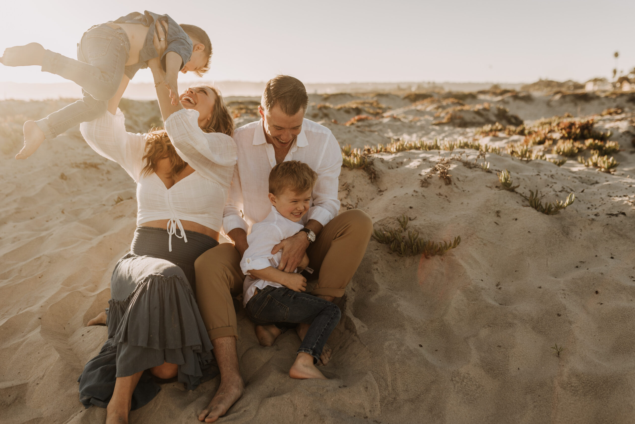 San Diego family photos warm sunset beach photos family of four candid family moments golden hour light beach San Diego family photographer Sabrina Kinsella