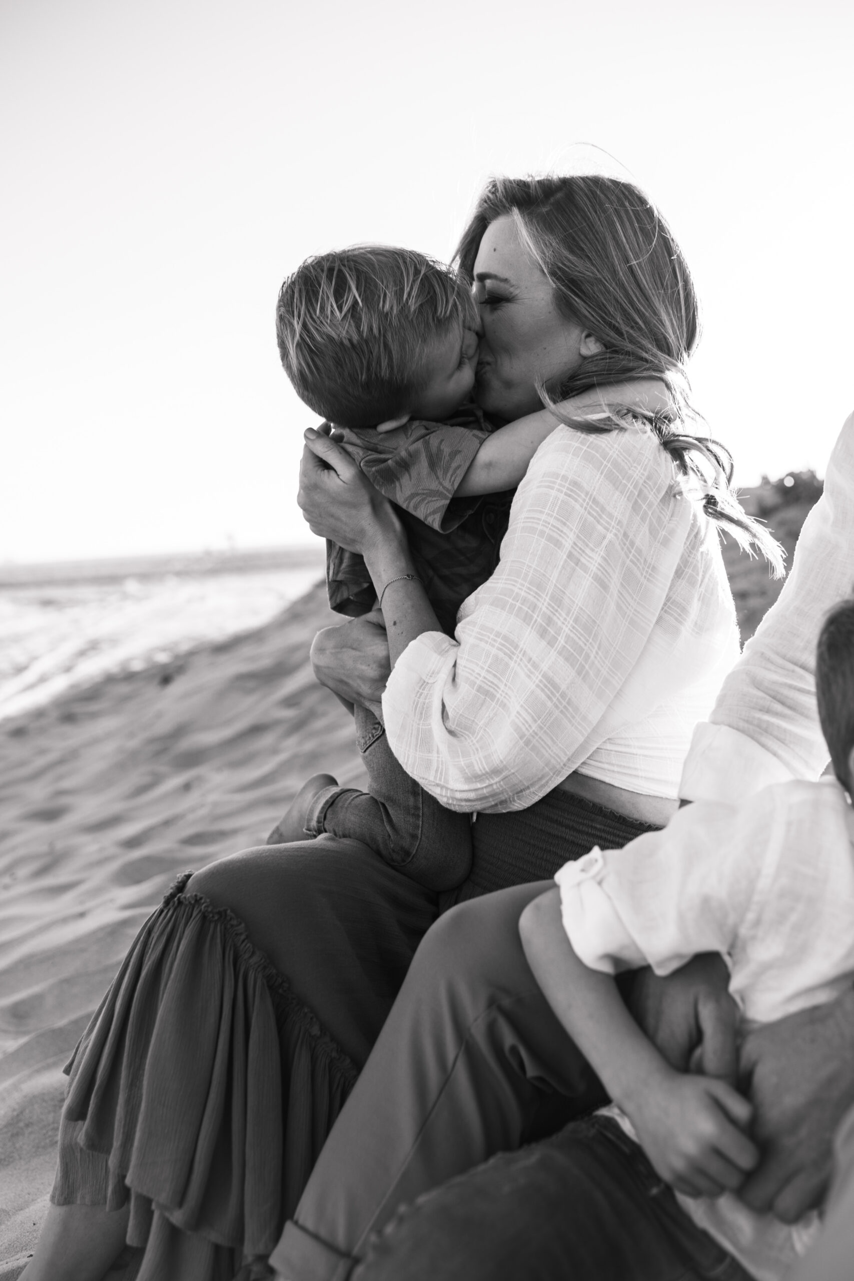 San Diego family photos warm sunset beach photos family of four candid family moments golden hour light beach San Diego family photographer Sabrina Kinsella