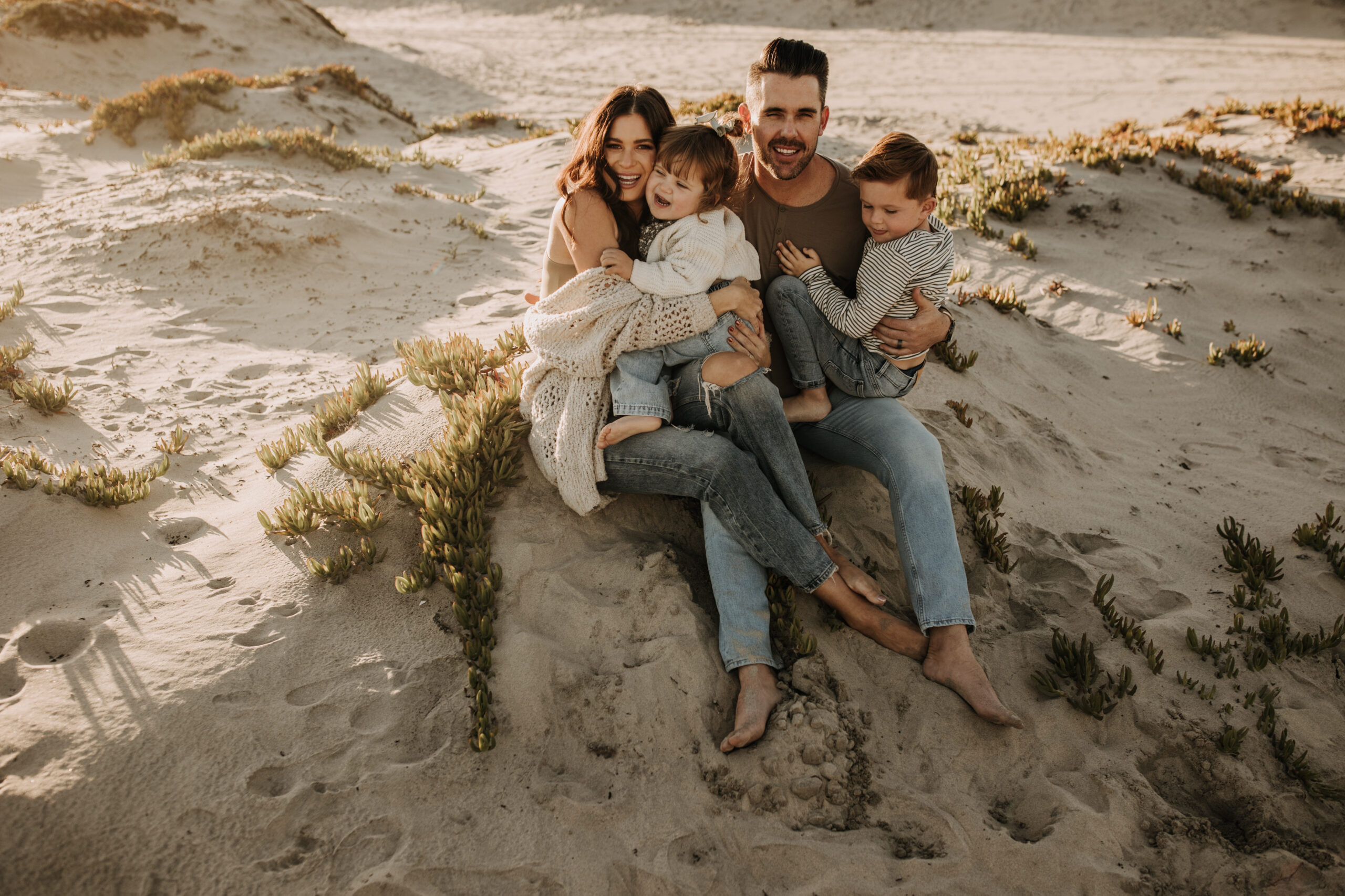 warm neutral sunset beach photos family photos on the beach golden hour family of four candid family photos love San Diego family photographer Sabrina kinsella