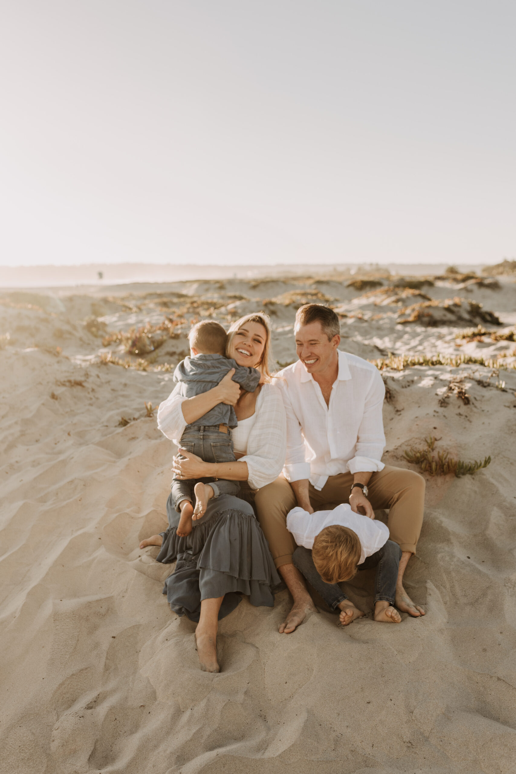 San Diego family photos warm sunset beach photos family of four candid family moments golden hour light beach San Diego family photographer Sabrina Kinsella