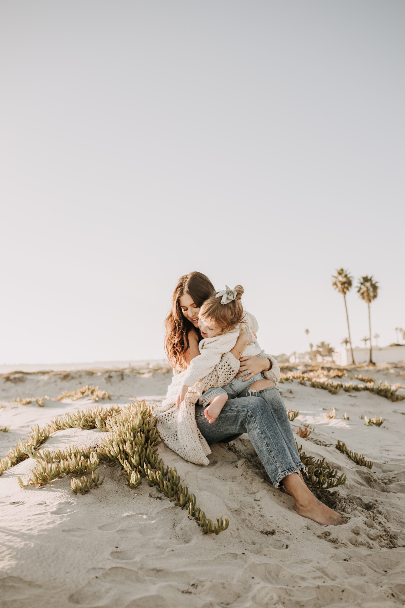 warm neutral sunset beach photos family photos on the beach golden hour family of four candid family photos love San Diego family photographer Sabrina kinsella