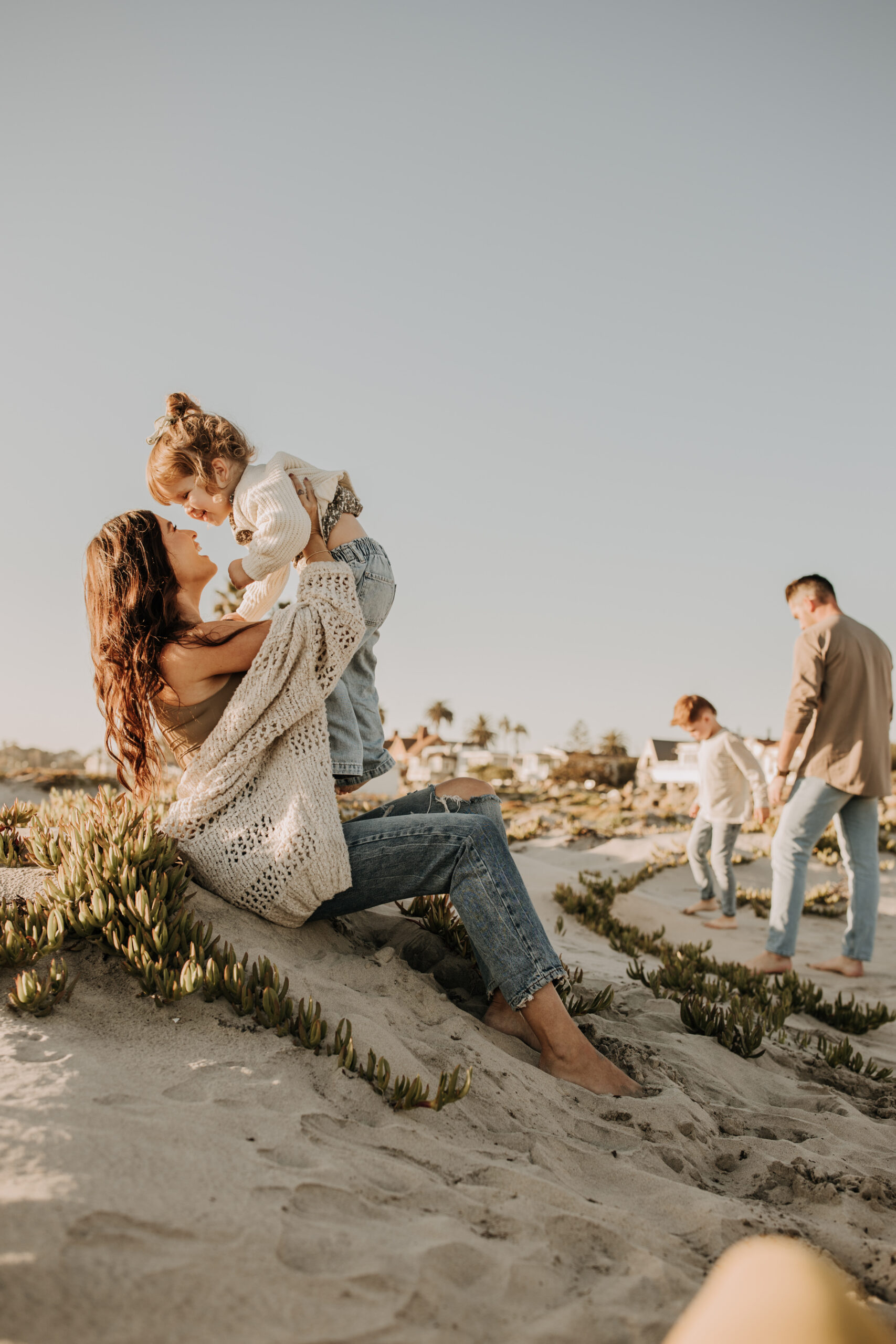 warm neutral sunset beach photos family photos on the beach golden hour family of four candid family photos love San Diego family photographer Sabrina kinsella