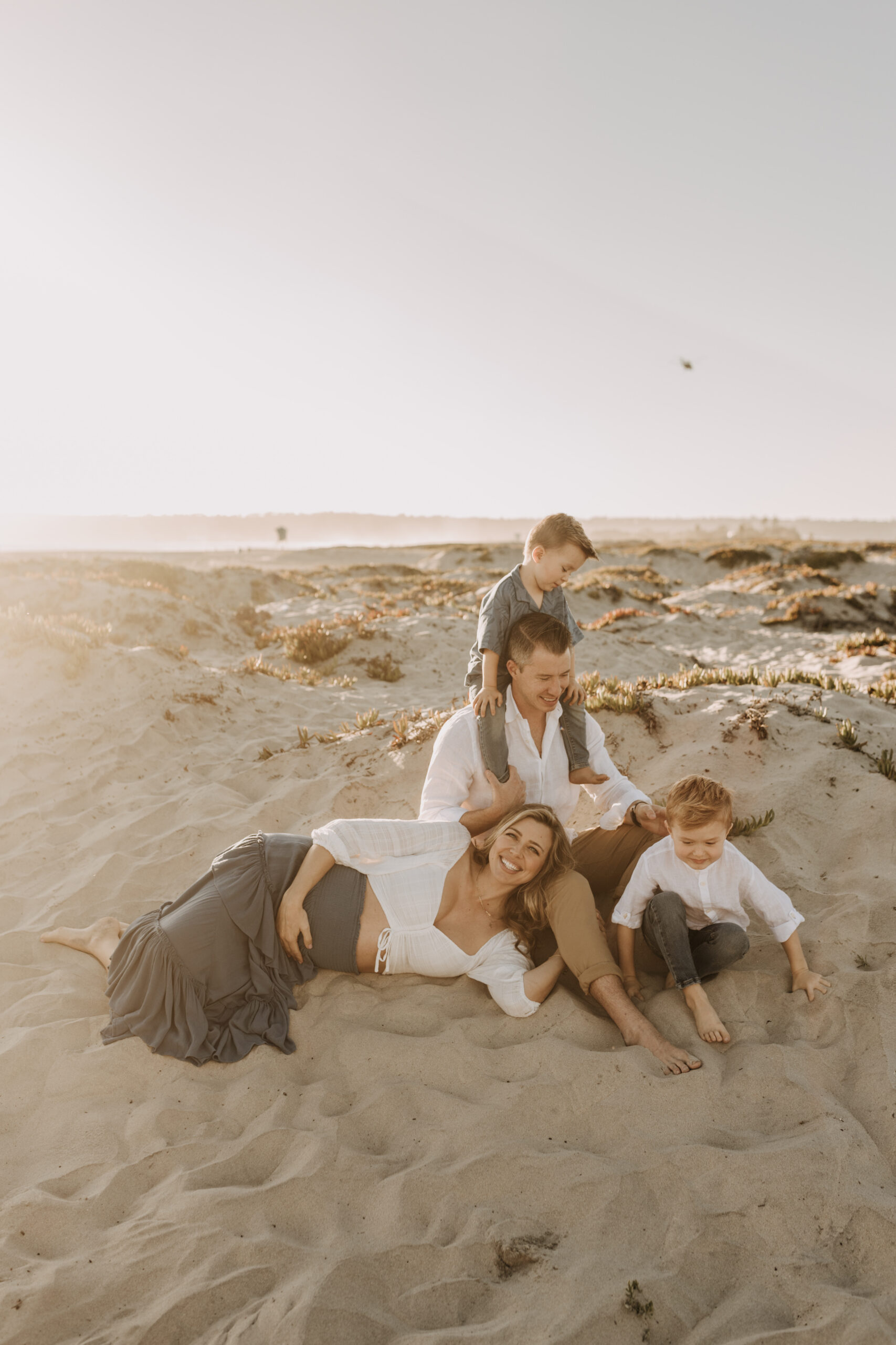 San Diego family photos warm sunset beach photos family of four candid family moments golden hour light beach San Diego family photographer Sabrina Kinsella