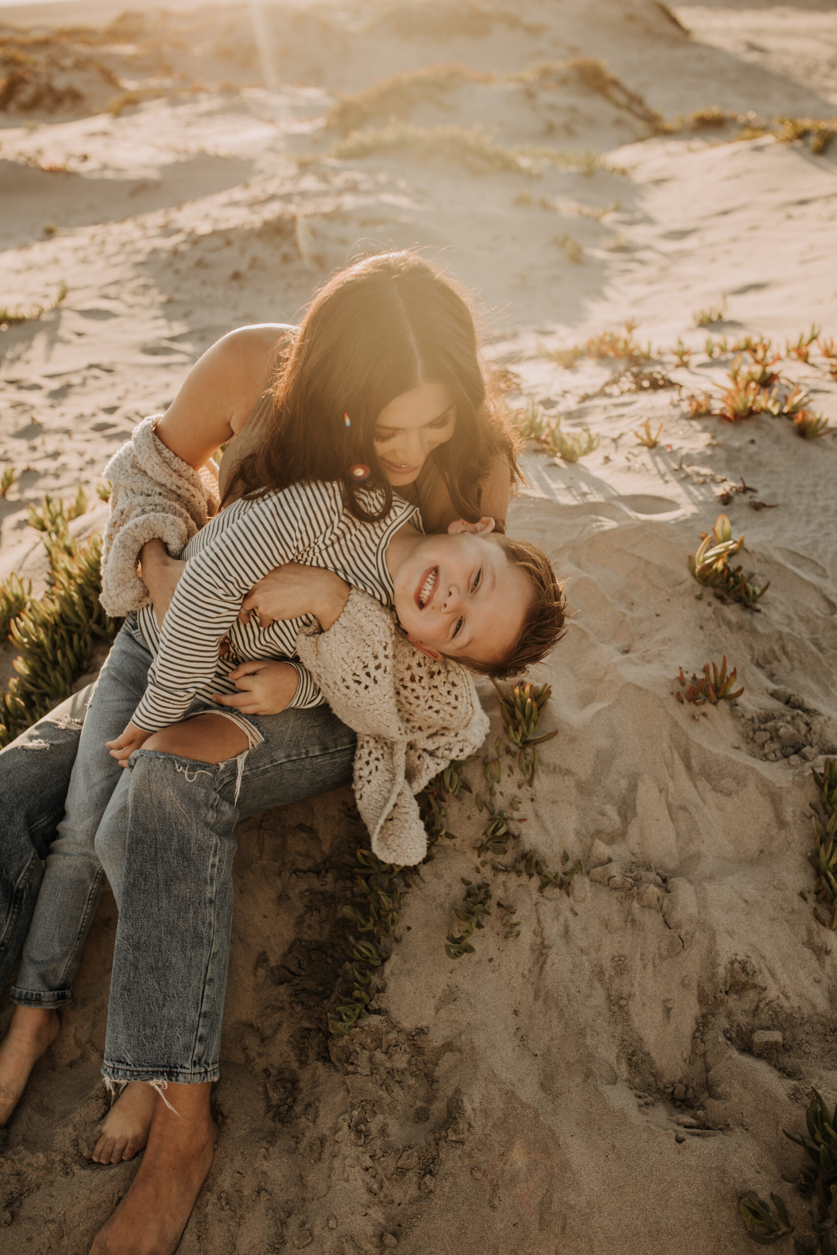 warm neutral sunset beach photos family photos on the beach golden hour family of four candid family photos love San Diego family photographer Sabrina kinsella