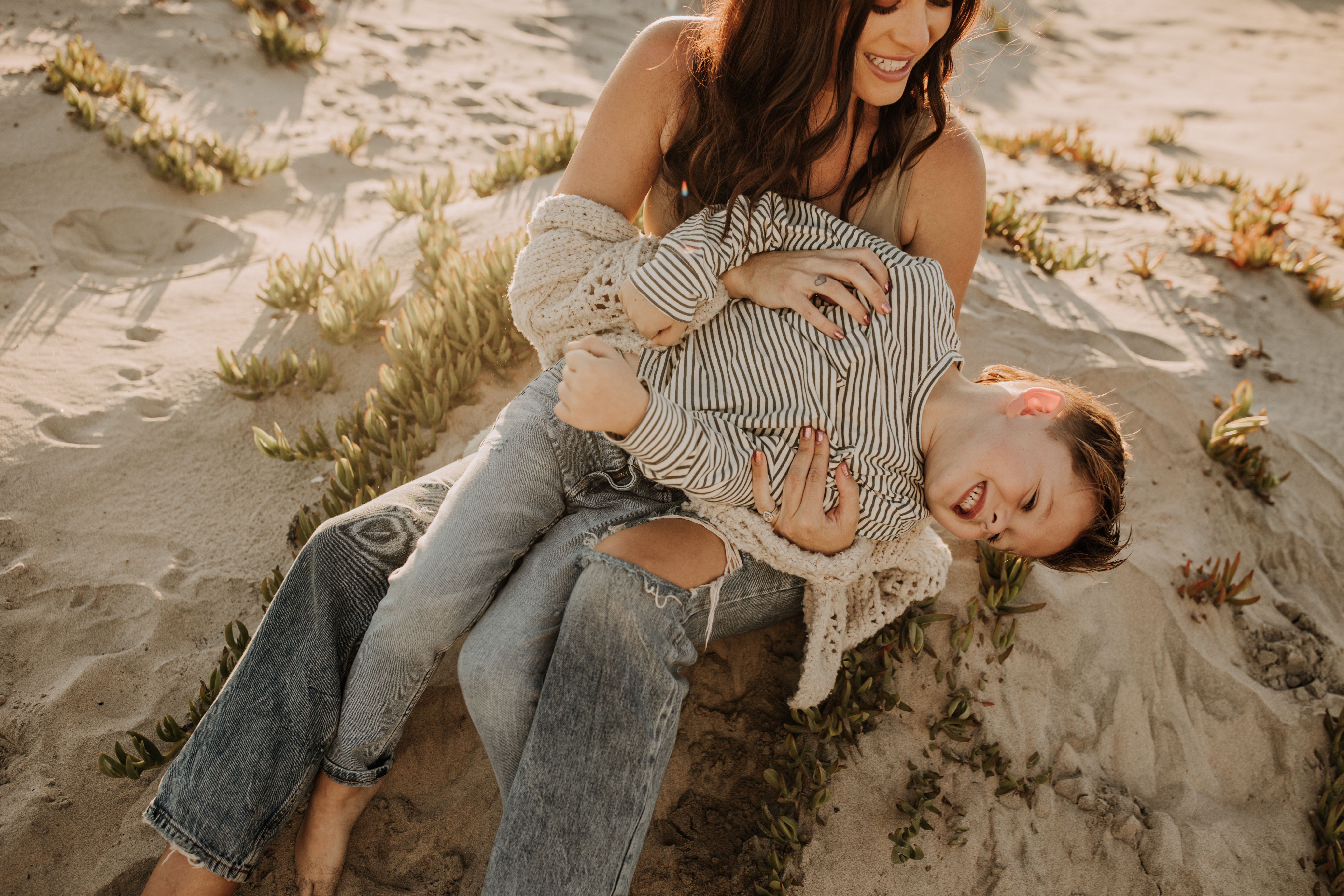 warm neutral sunset beach photos family photos on the beach golden hour family of four candid family photos love San Diego family photographer Sabrina kinsella 