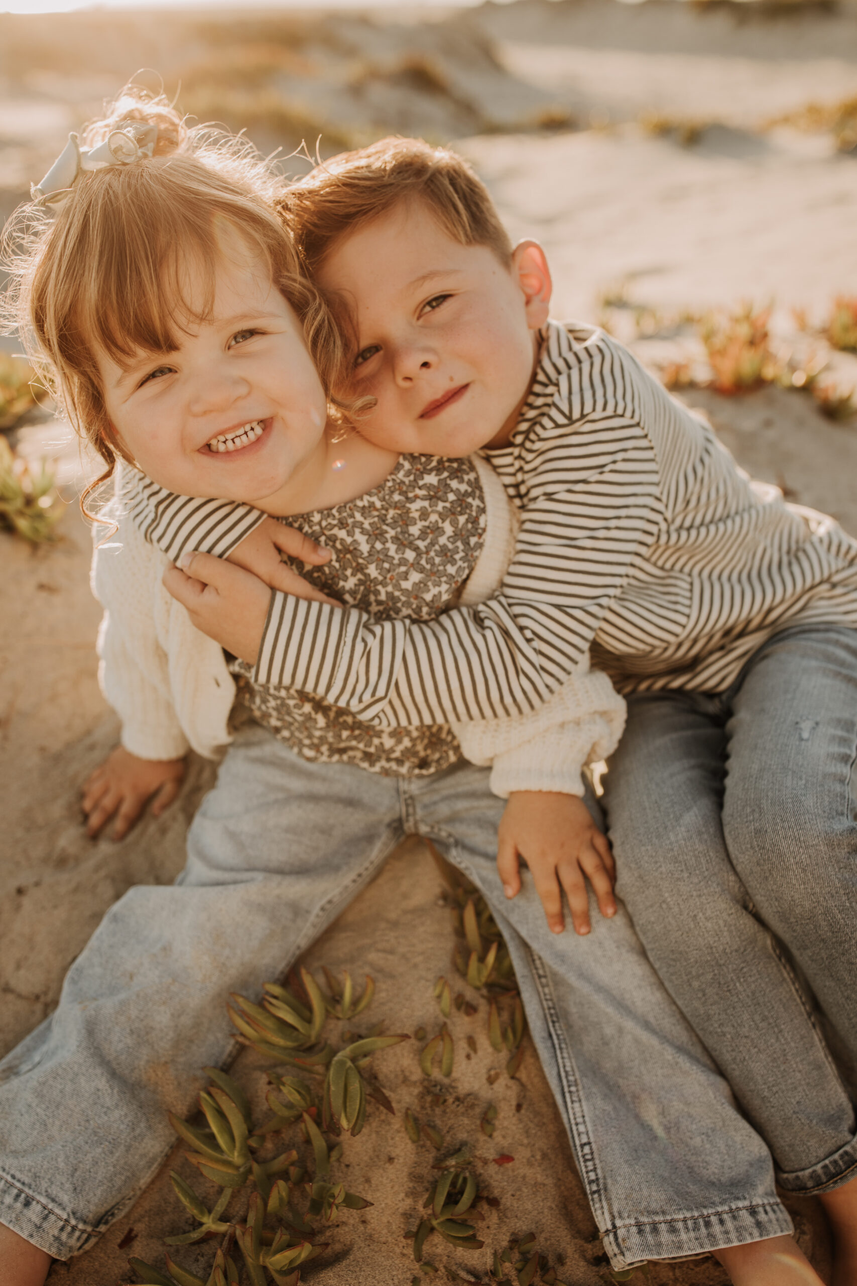 warm neutral sunset beach photos family photos on the beach golden hour family of four candid family photos love San Diego family photographer Sabrina kinsella