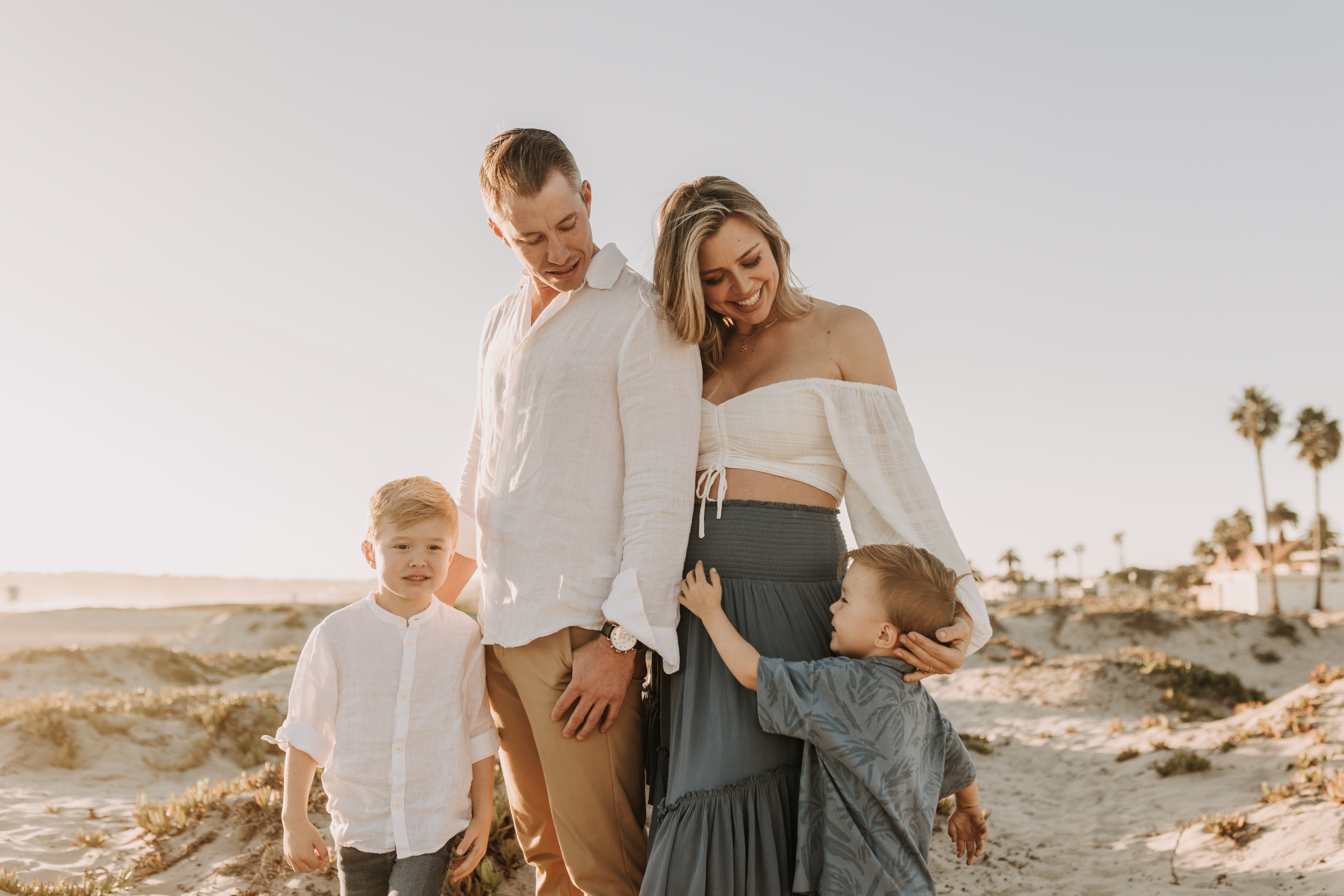 San Diego family photos warm sunset beach photos family of four candid family moments golden hour light beach San Diego family photographer Sabrina Kinsella 