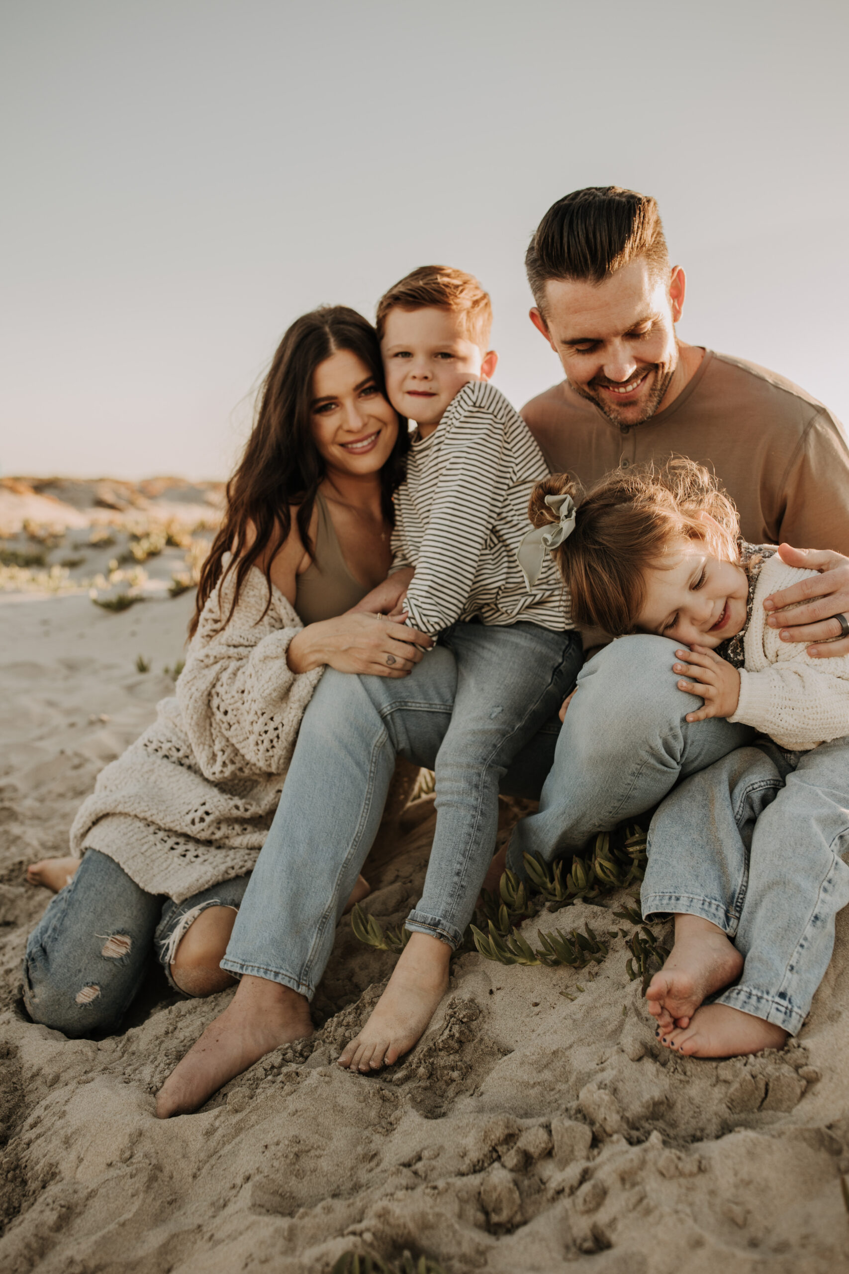 warm neutral sunset beach photos family photos on the beach golden hour family of four candid family photos love San Diego family photographer Sabrina kinsella