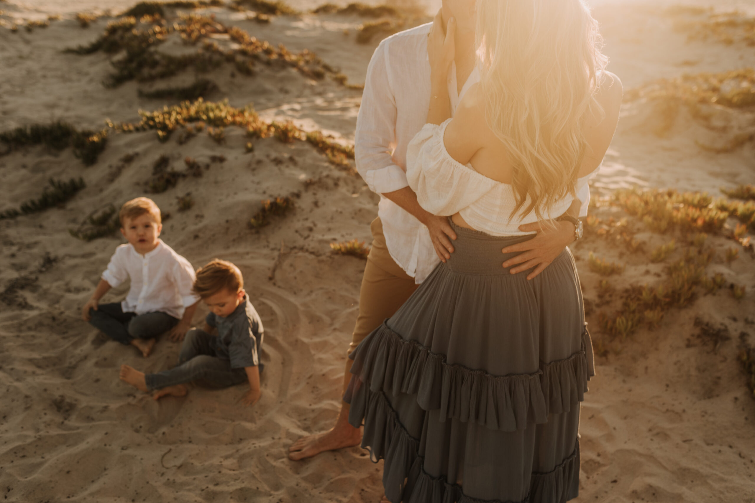 San Diego family photos warm sunset beach photos family of four candid family moments golden hour light beach San Diego family photographer Sabrina Kinsella