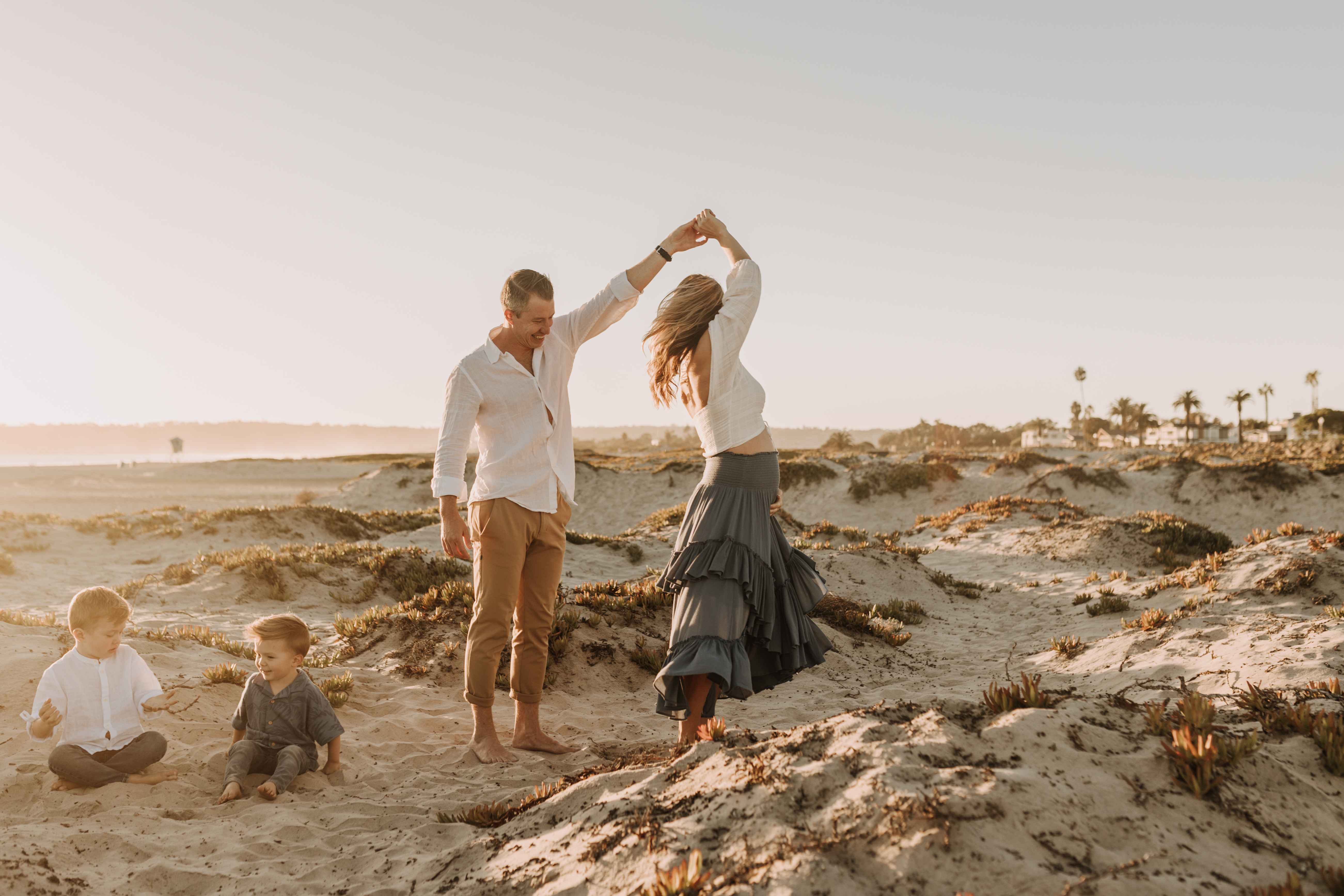 San Diego family photos warm sunset beach photos family of four candid family moments golden hour light beach San Diego family photographer Sabrina Kinsella 