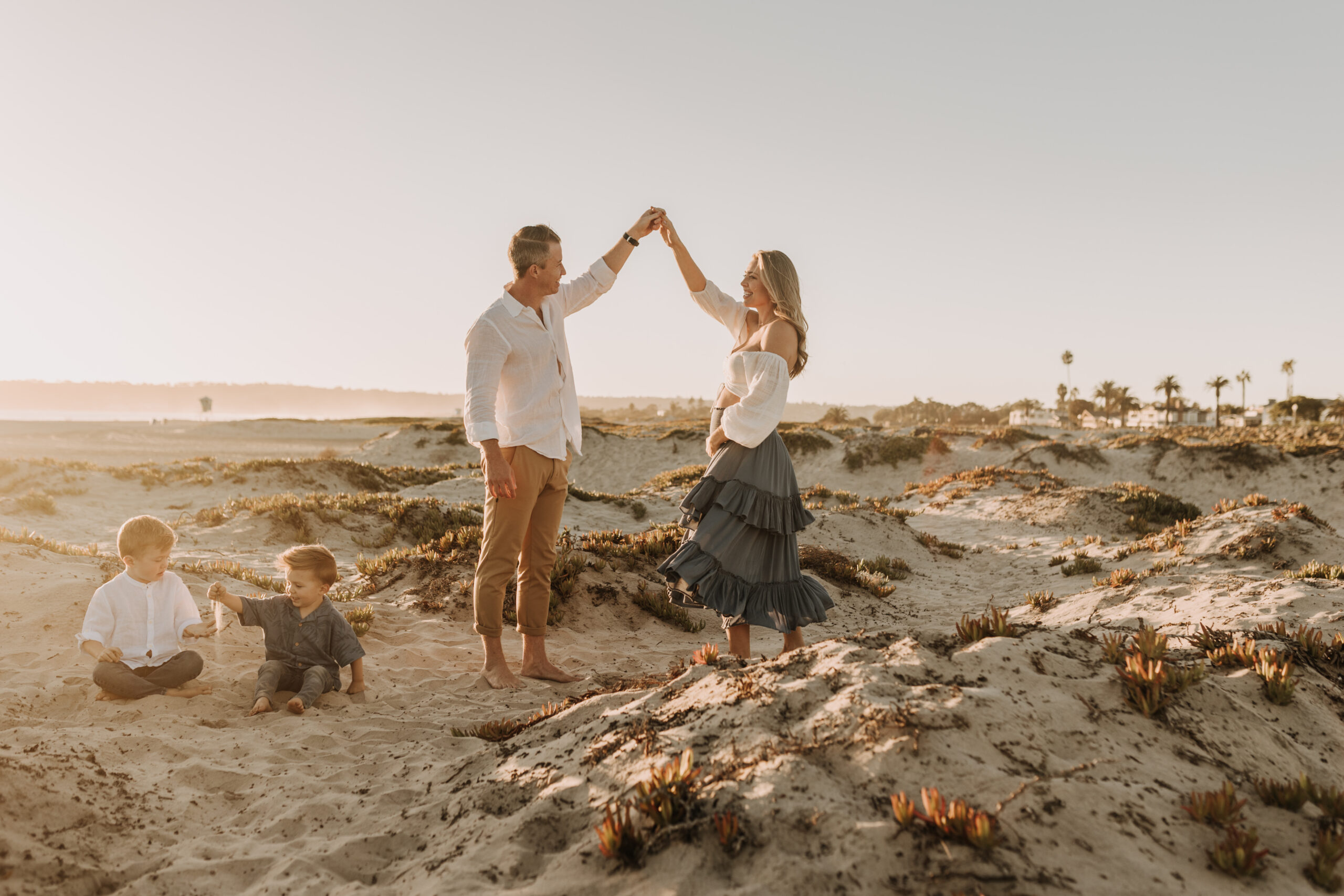 San Diego family photos warm sunset beach photos family of four candid family moments golden hour light beach San Diego family photographer Sabrina Kinsella