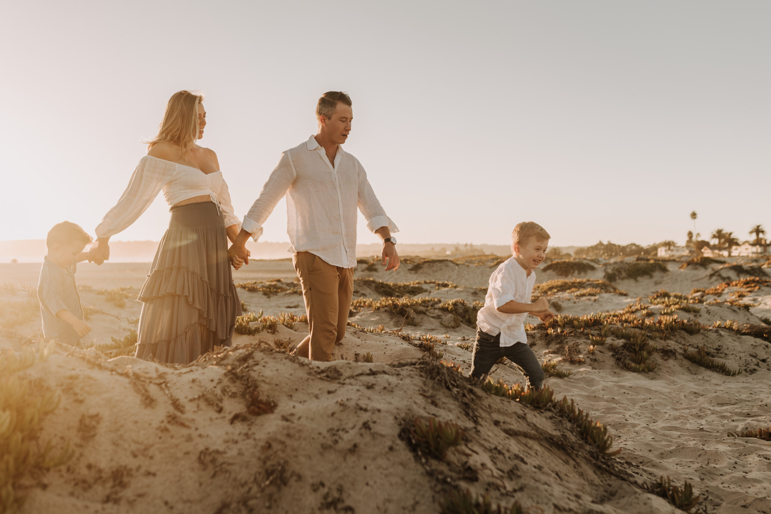 San Diego family photos warm sunset beach photos family of four candid family moments golden hour light beach San Diego family photographer Sabrina Kinsella