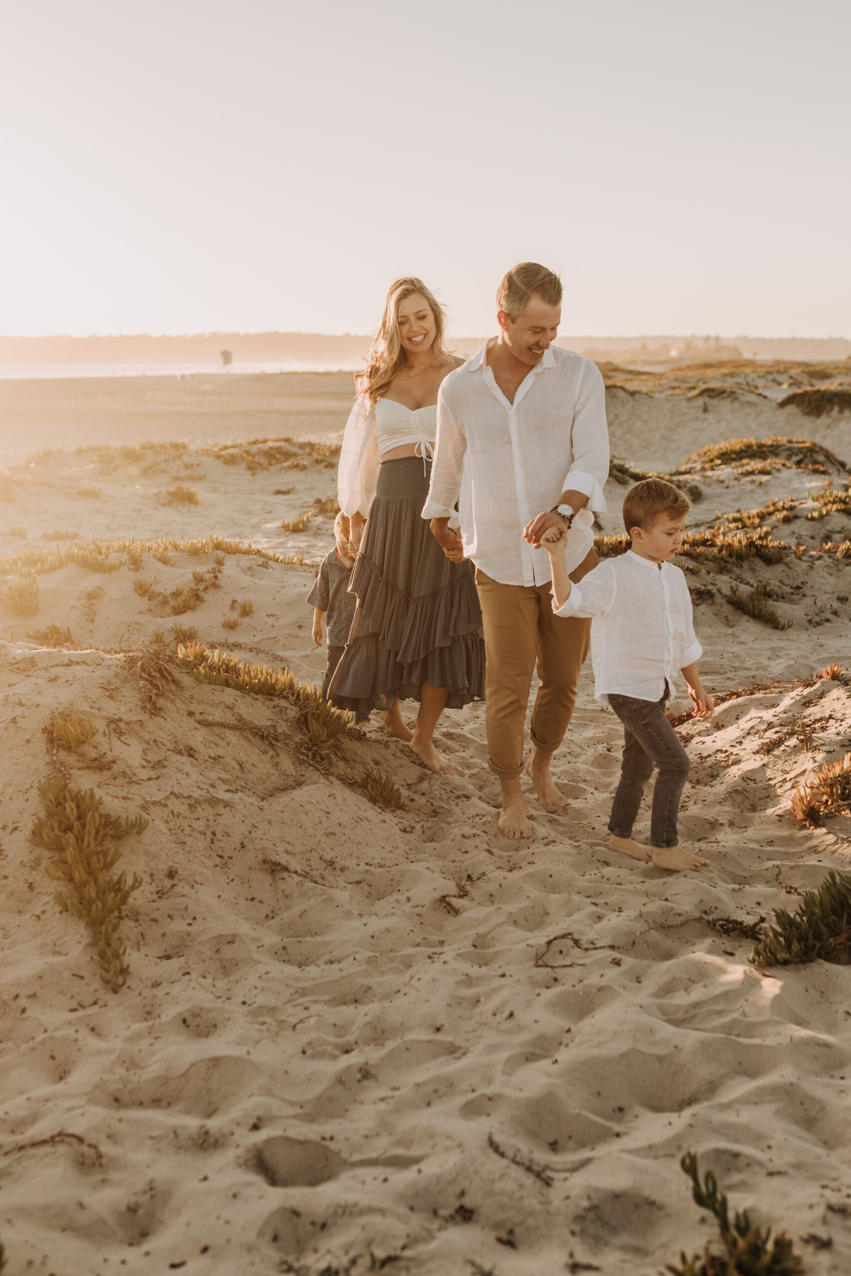 San Diego family photos warm sunset beach photos family of four candid family moments golden hour light beach San Diego family photographer Sabrina Kinsella