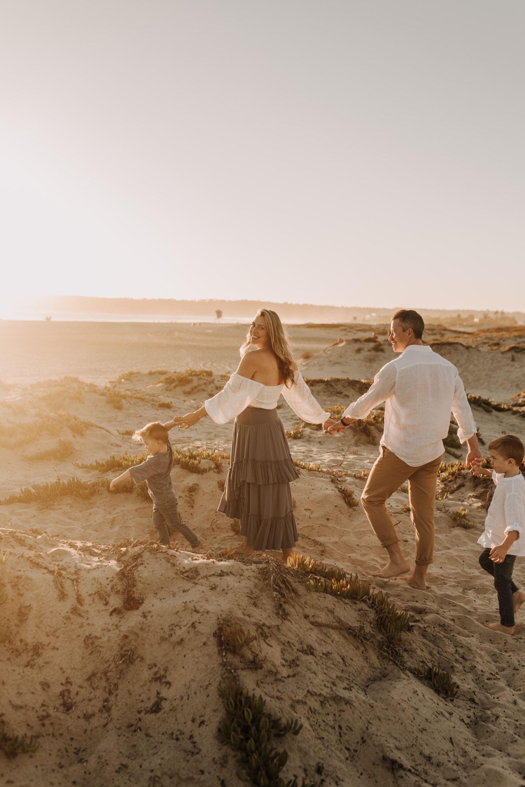 San Diego family photos warm sunset beach photos family of four candid family moments golden hour light beach San Diego family photographer Sabrina Kinsella