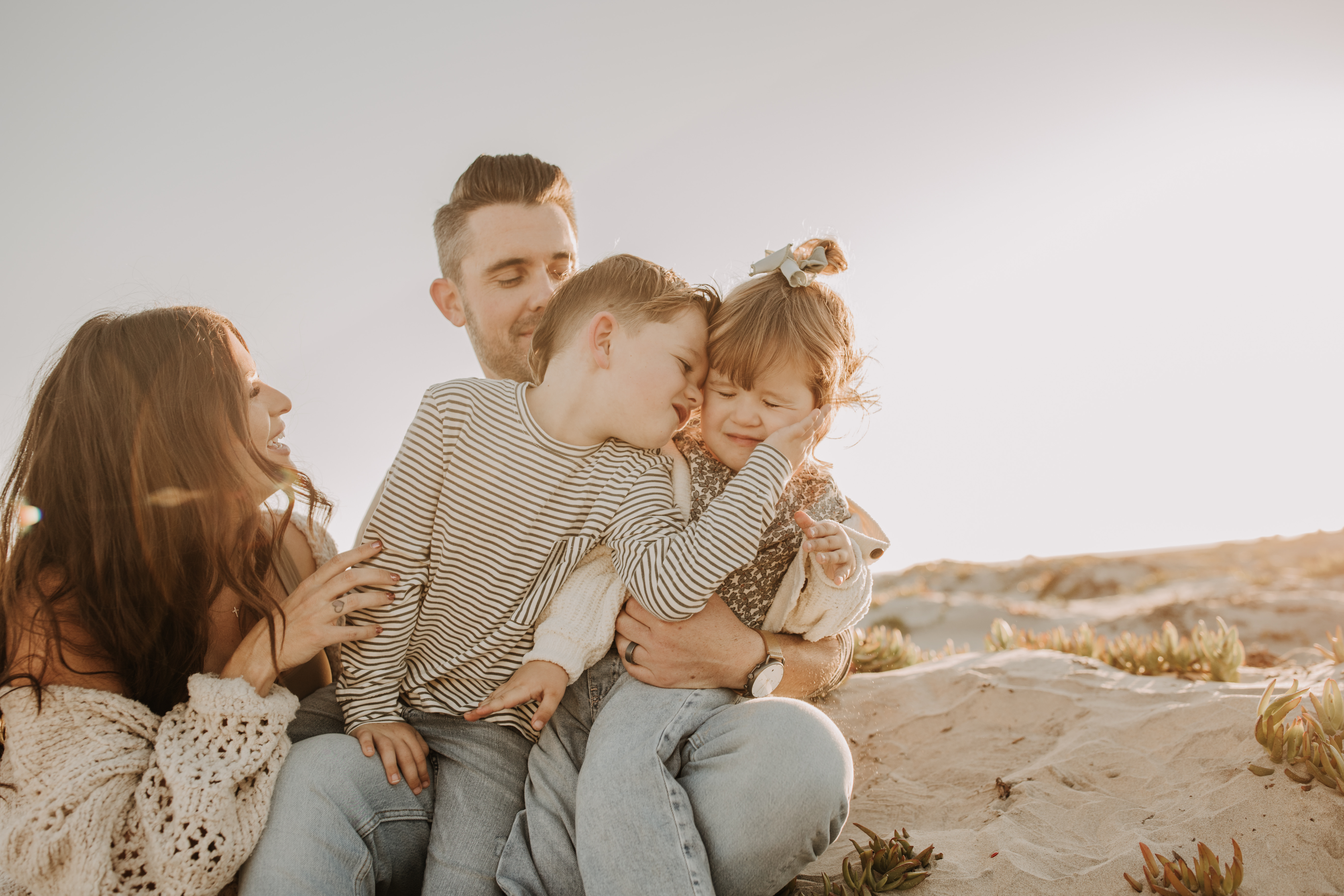 warm neutral sunset beach photos family photos on the beach golden hour family of four candid family photos love San Diego family photographer Sabrina kinsella 