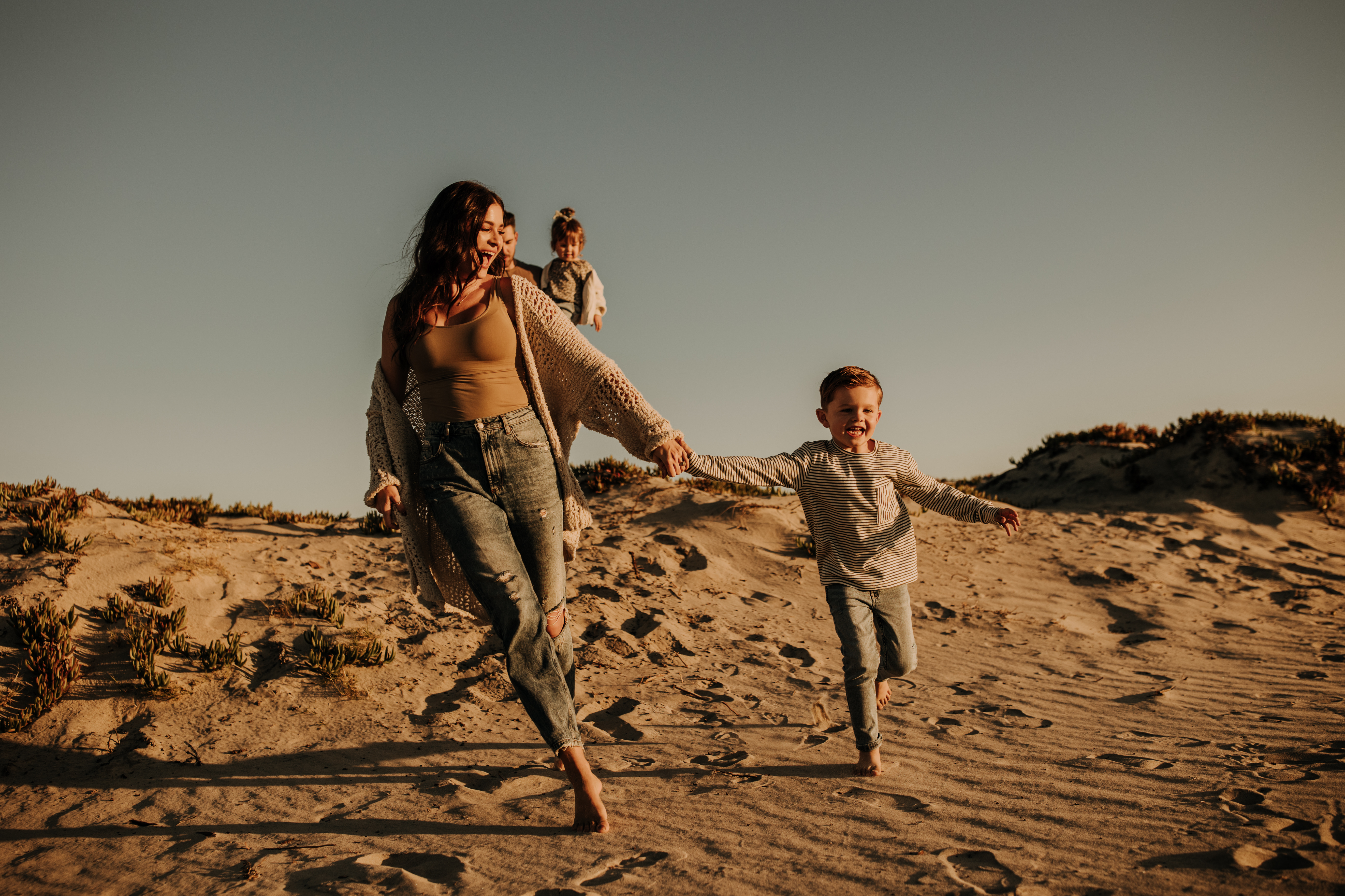 warm neutral sunset beach photos family photos on the beach golden hour family of four candid family photos love San Diego family photographer Sabrina kinsella 