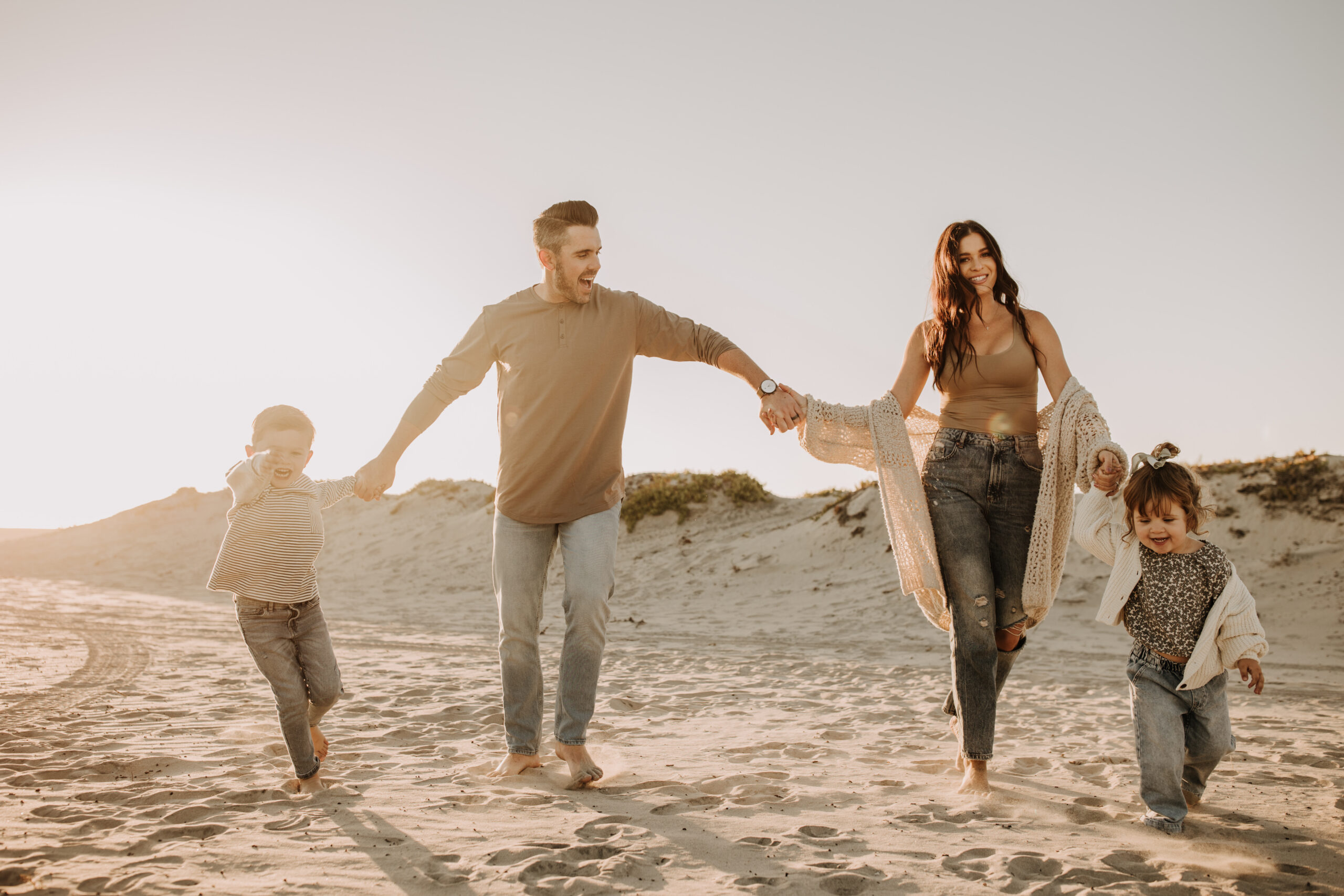 warm neutral sunset beach photos family photos on the beach golden hour family of four candid family photos love San Diego family photographer Sabrina kinsella