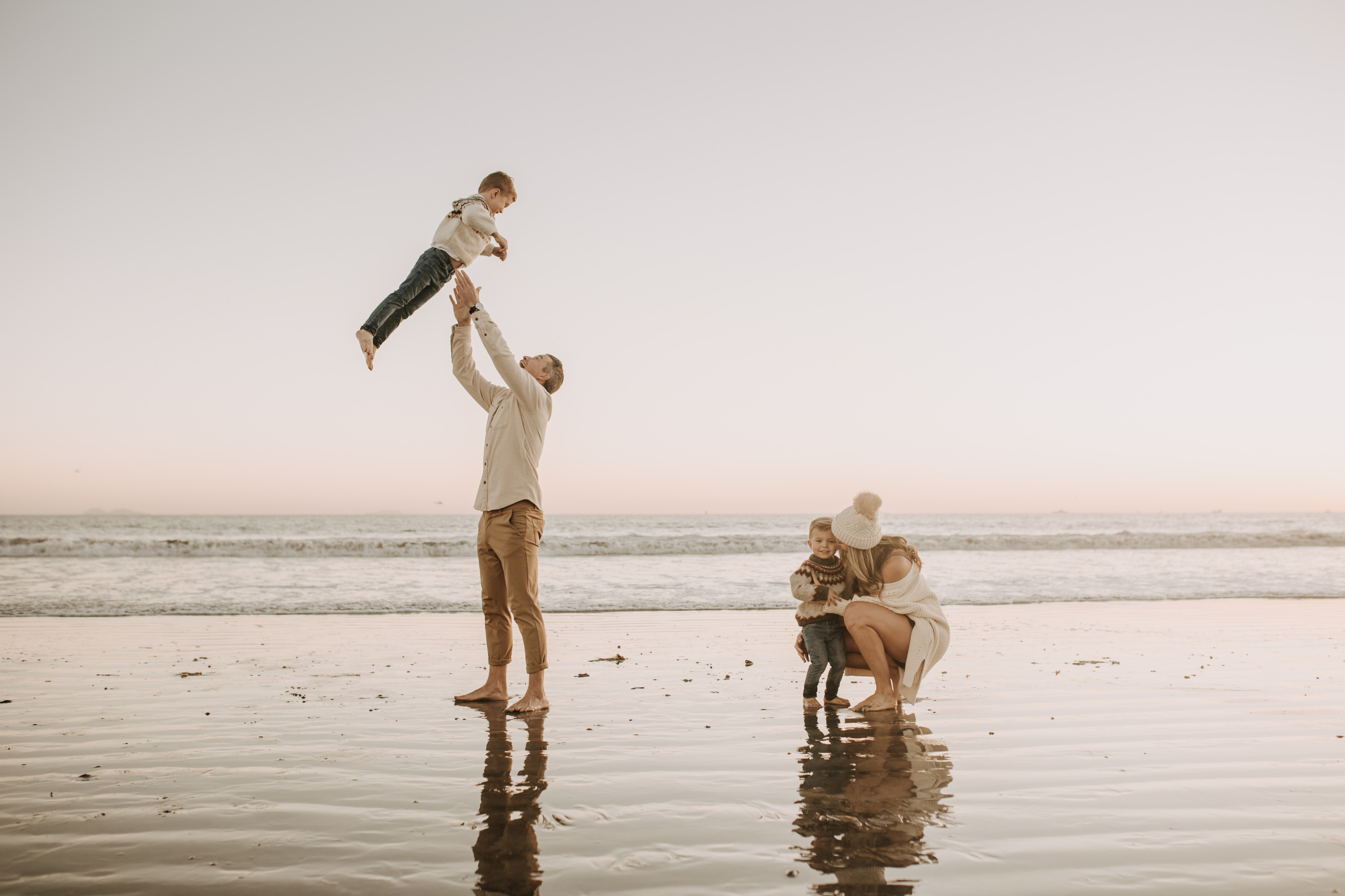 San Diego family photos warm sunset beach photos family of four candid family moments golden hour light beach San Diego family photographer Sabrina Kinsella 