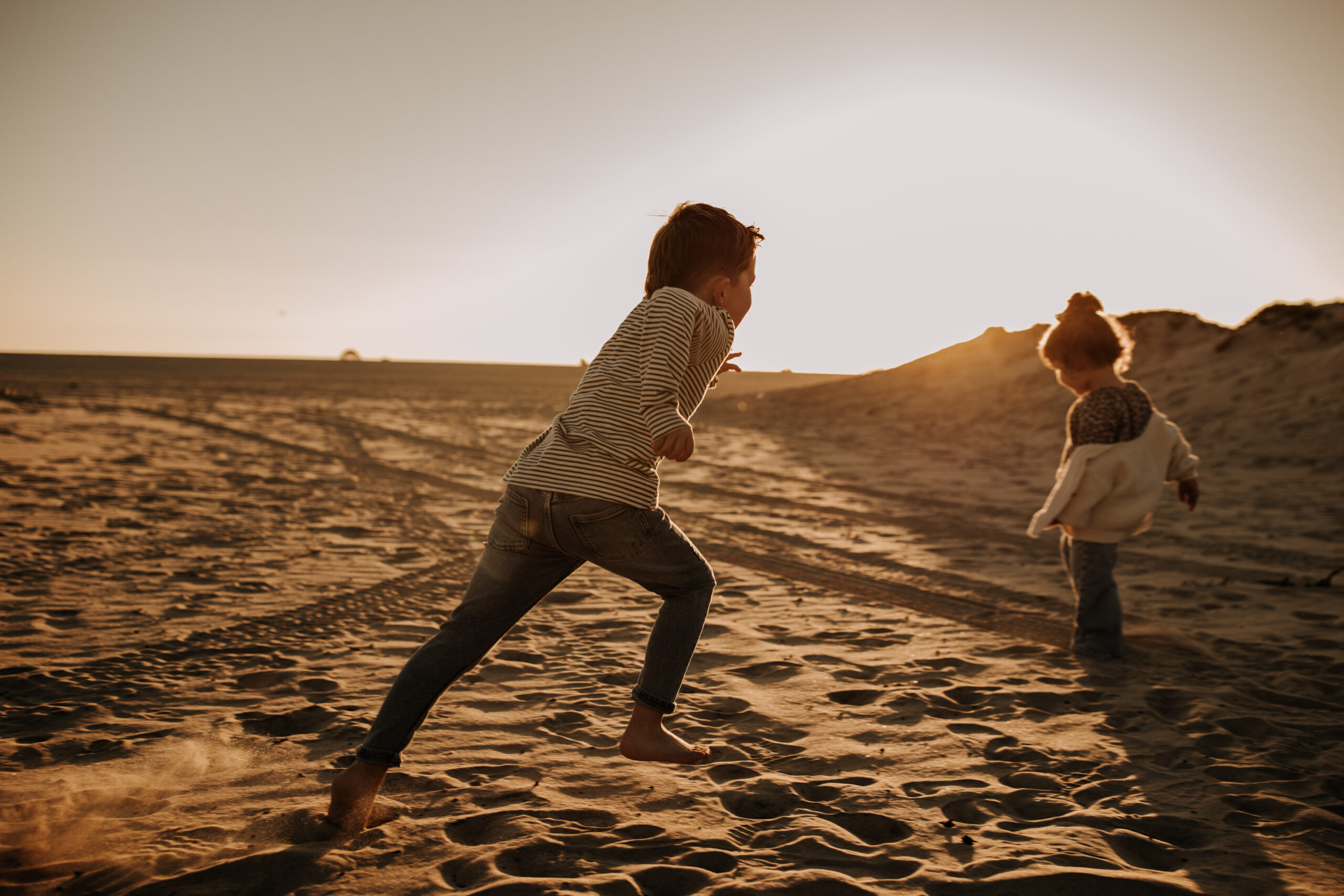 warm neutral sunset beach photos family photos on the beach golden hour family of four candid family photos love San Diego family photographer Sabrina kinsella