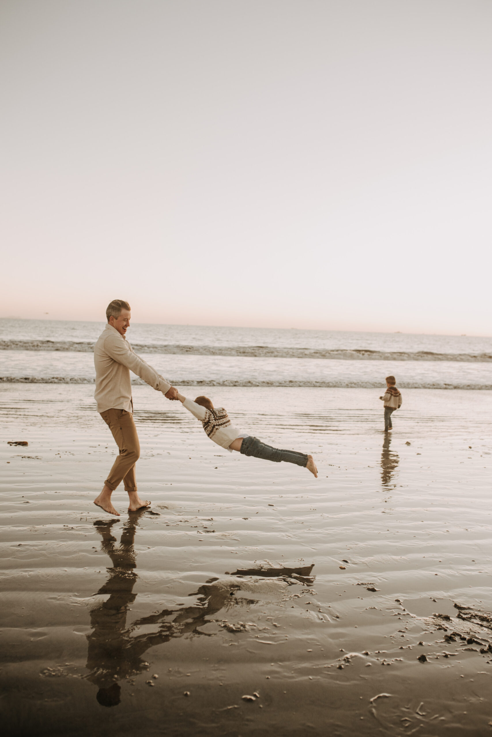 San Diego family photos warm sunset beach photos family of four candid family moments golden hour light beach San Diego family photographer Sabrina Kinsella