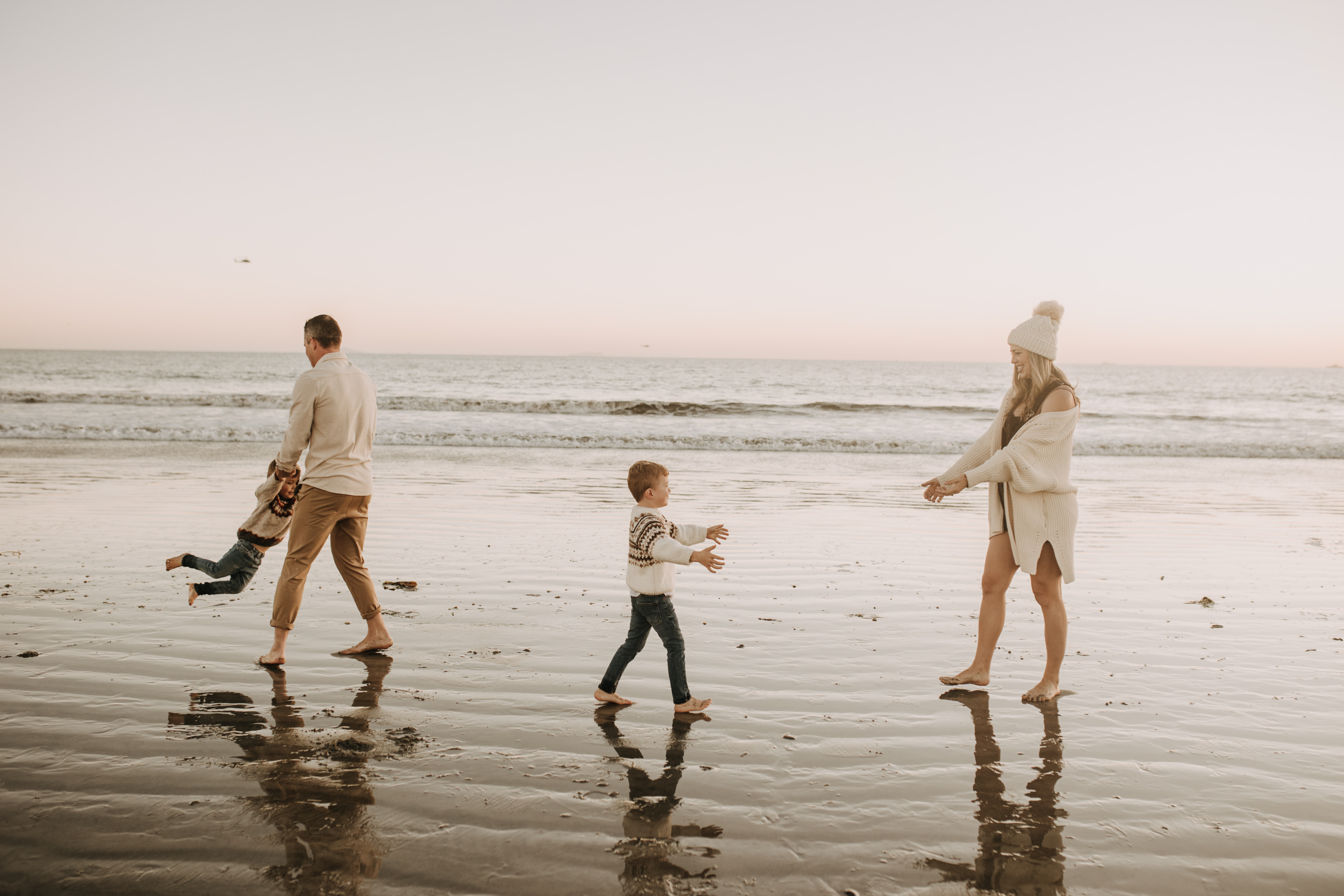 San Diego family photos warm sunset beach photos family of four candid family moments golden hour light beach San Diego family photographer Sabrina Kinsella 