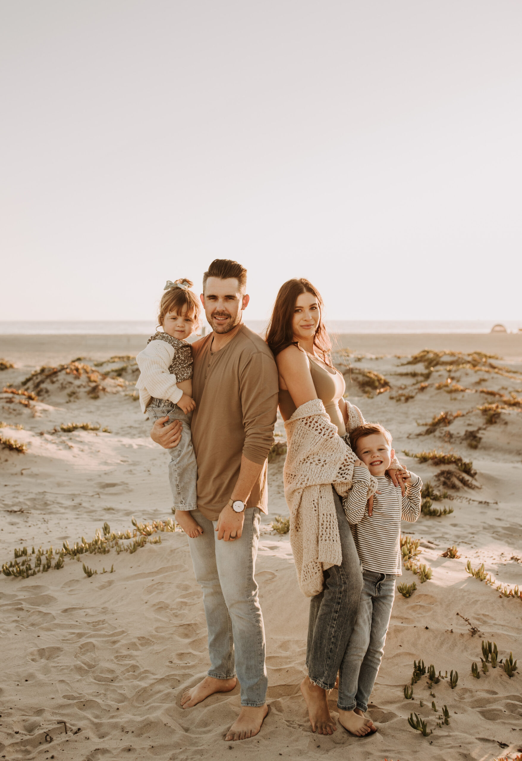 warm neutral sunset beach photos family photos on the beach golden hour family of four candid family photos love San Diego family photographer Sabrina kinsella