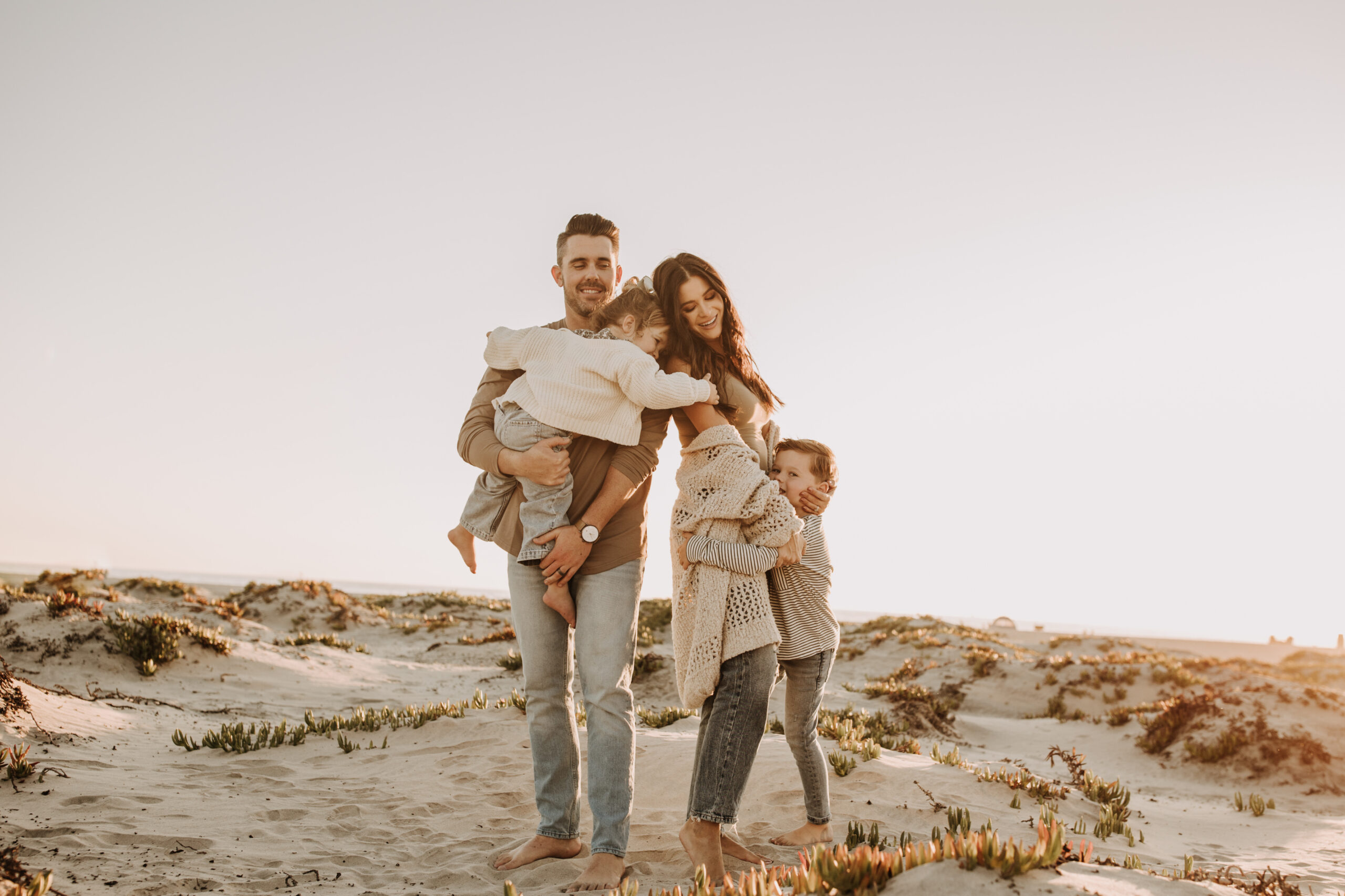 warm neutral sunset beach photos family photos on the beach golden hour family of four candid family photos love San Diego family photographer Sabrina kinsella