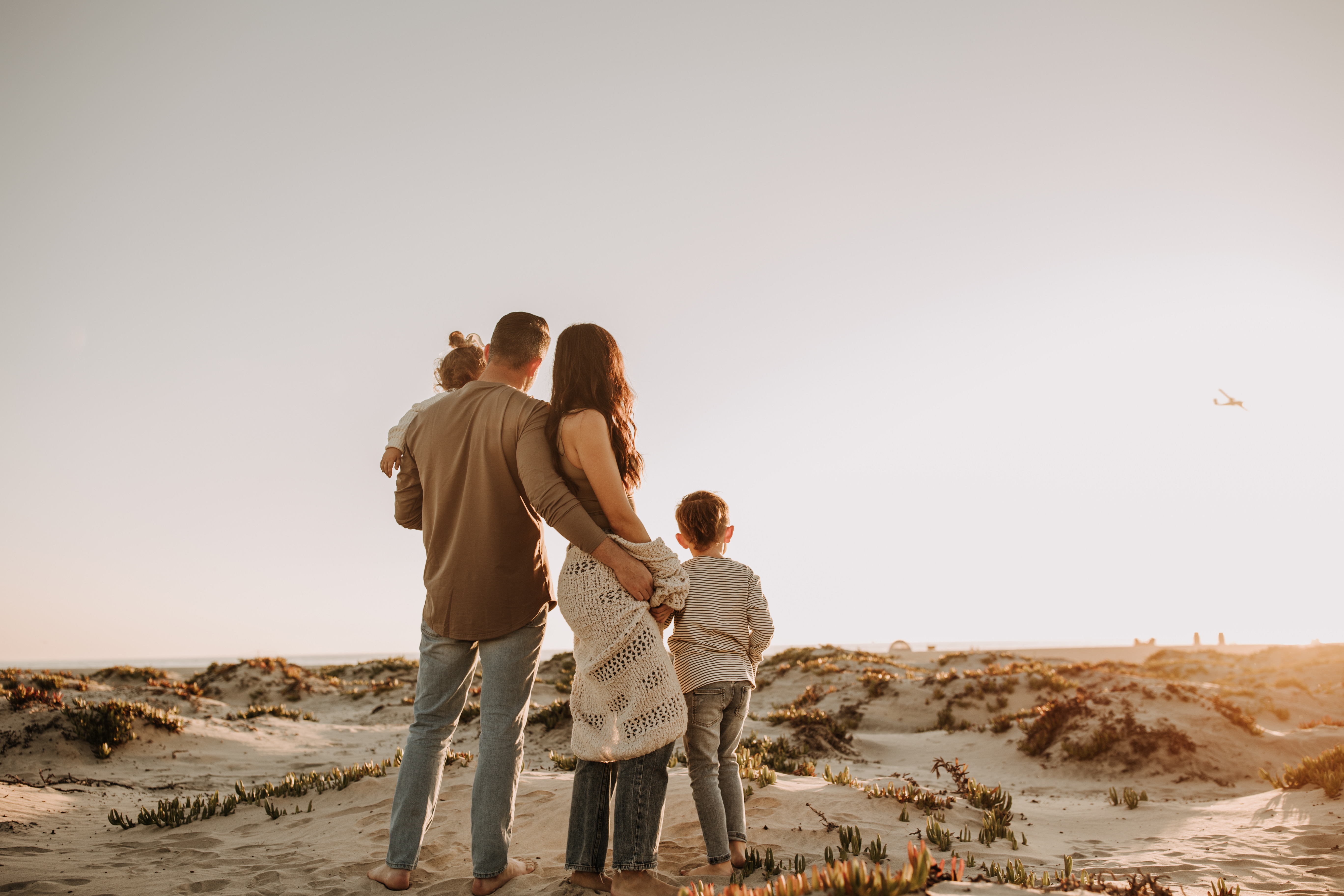 warm neutral sunset beach photos family photos on the beach golden hour family of four candid family photos love San Diego family photographer Sabrina kinsella 