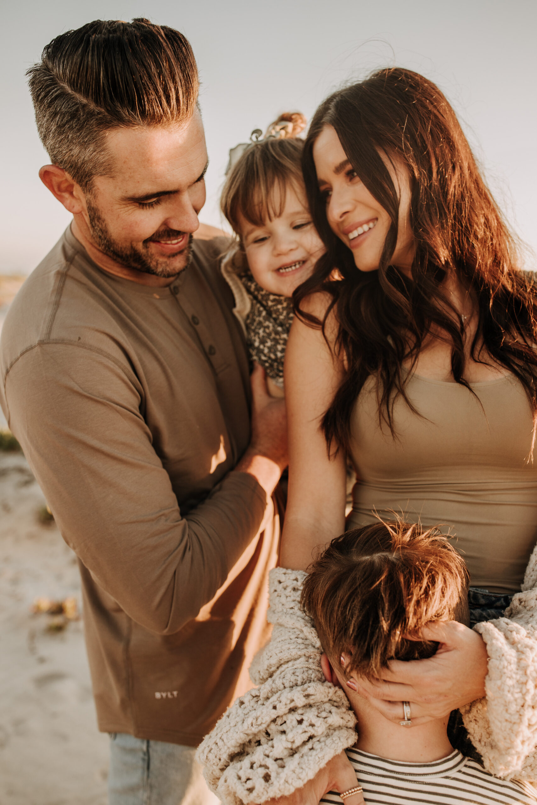 warm neutral sunset beach photos family photos on the beach golden hour family of four candid family photos love San Diego family photographer Sabrina kinsella