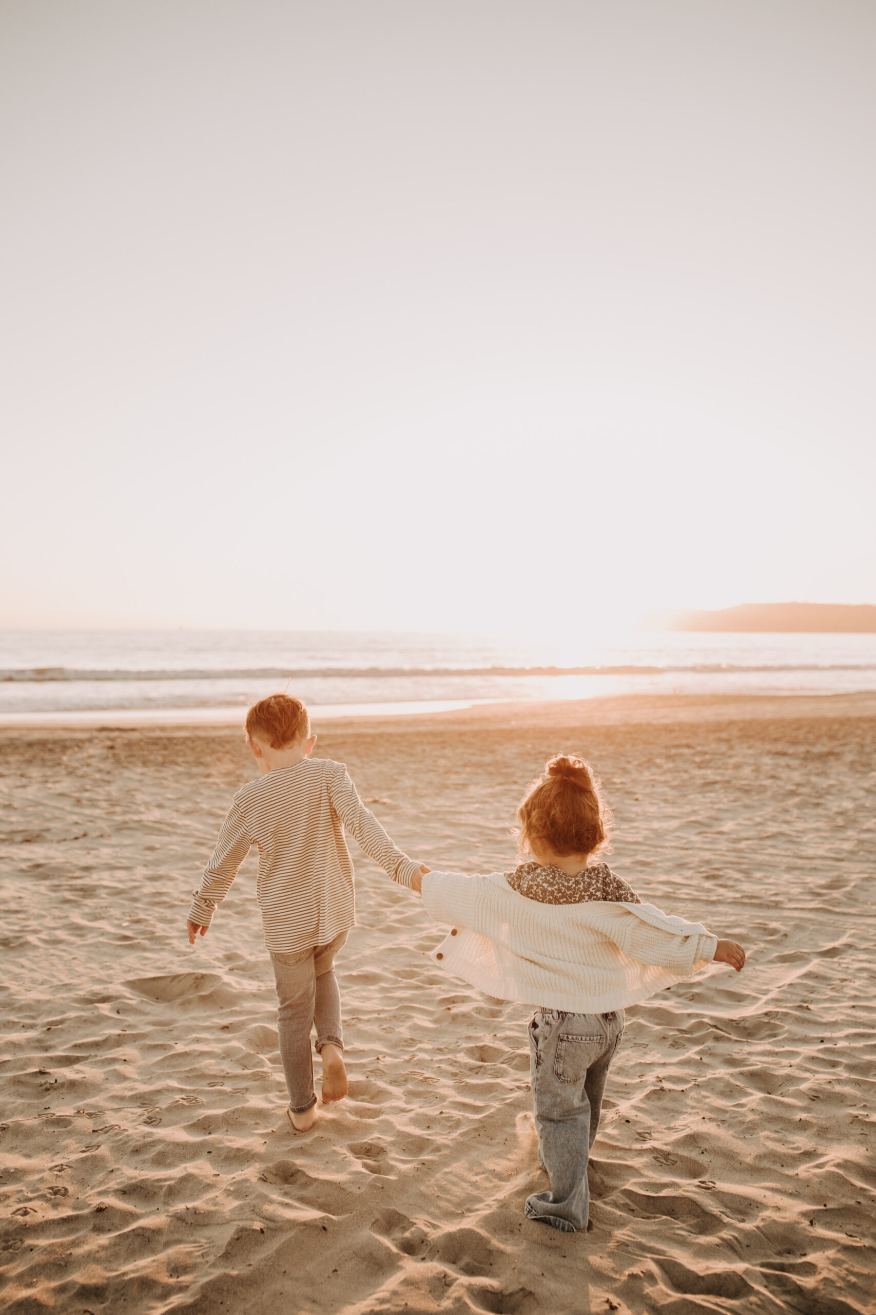 warm neutral sunset beach photos family photos on the beach golden hour family of four candid family photos love San Diego family photographer Sabrina kinsella