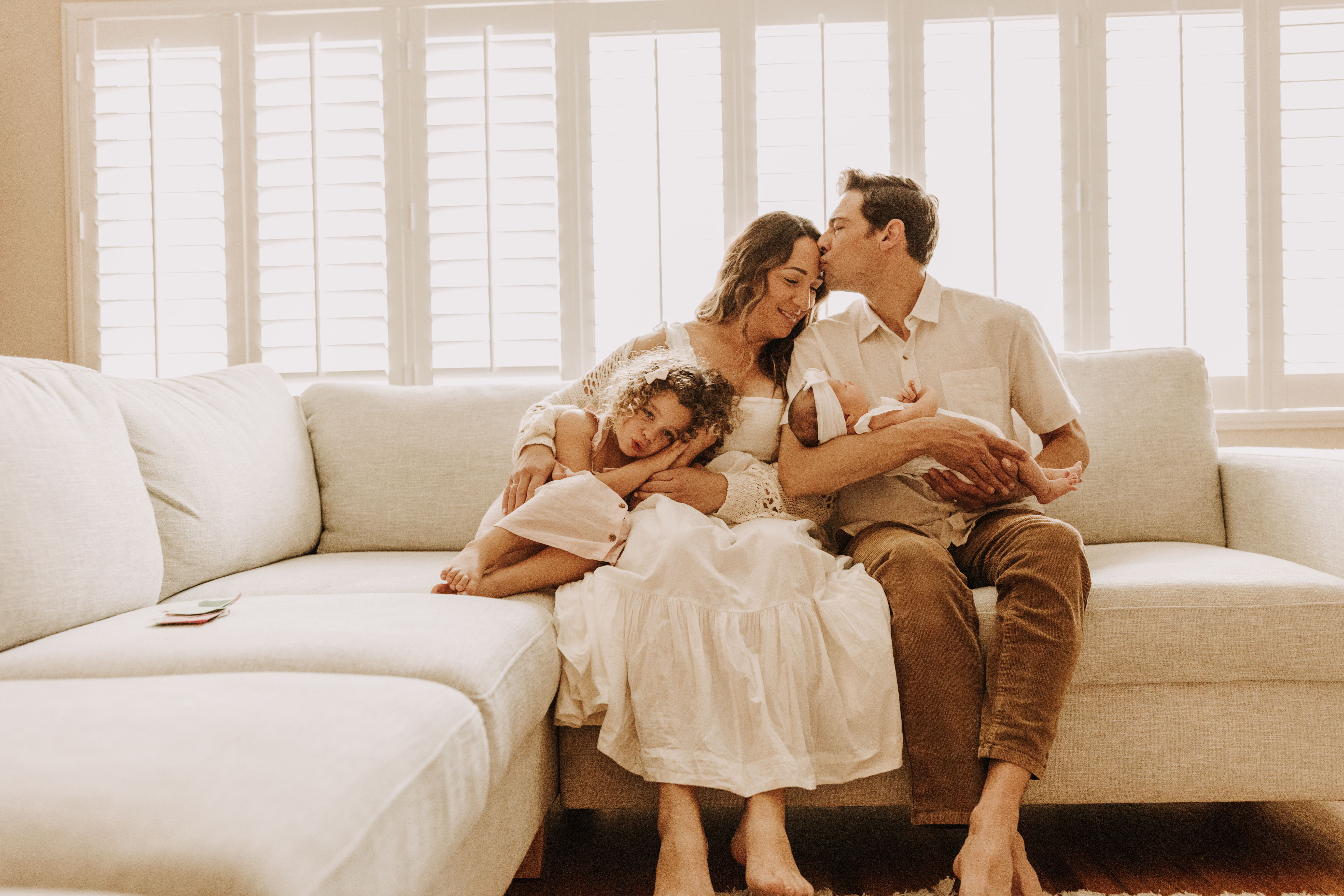 warm and cozy in home family session newborn photos newborn baby infant photos candid family moments neutral toned in home family of four San Diego family photographer Sabrina kinsella sabrinalynnphoto